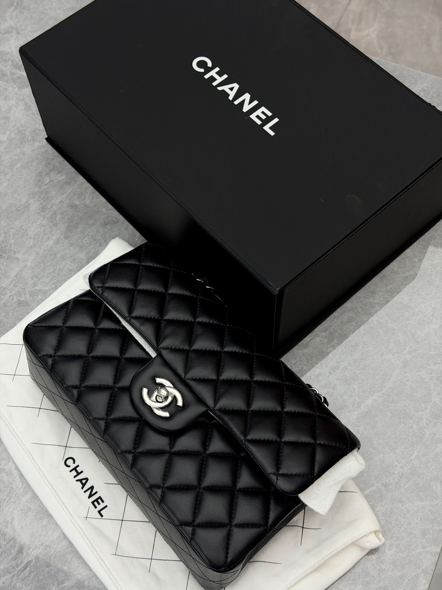 Chanel Classic Double Flap bag is crafted from black diamond-quilted lambskin leather and features silver-tone hardware