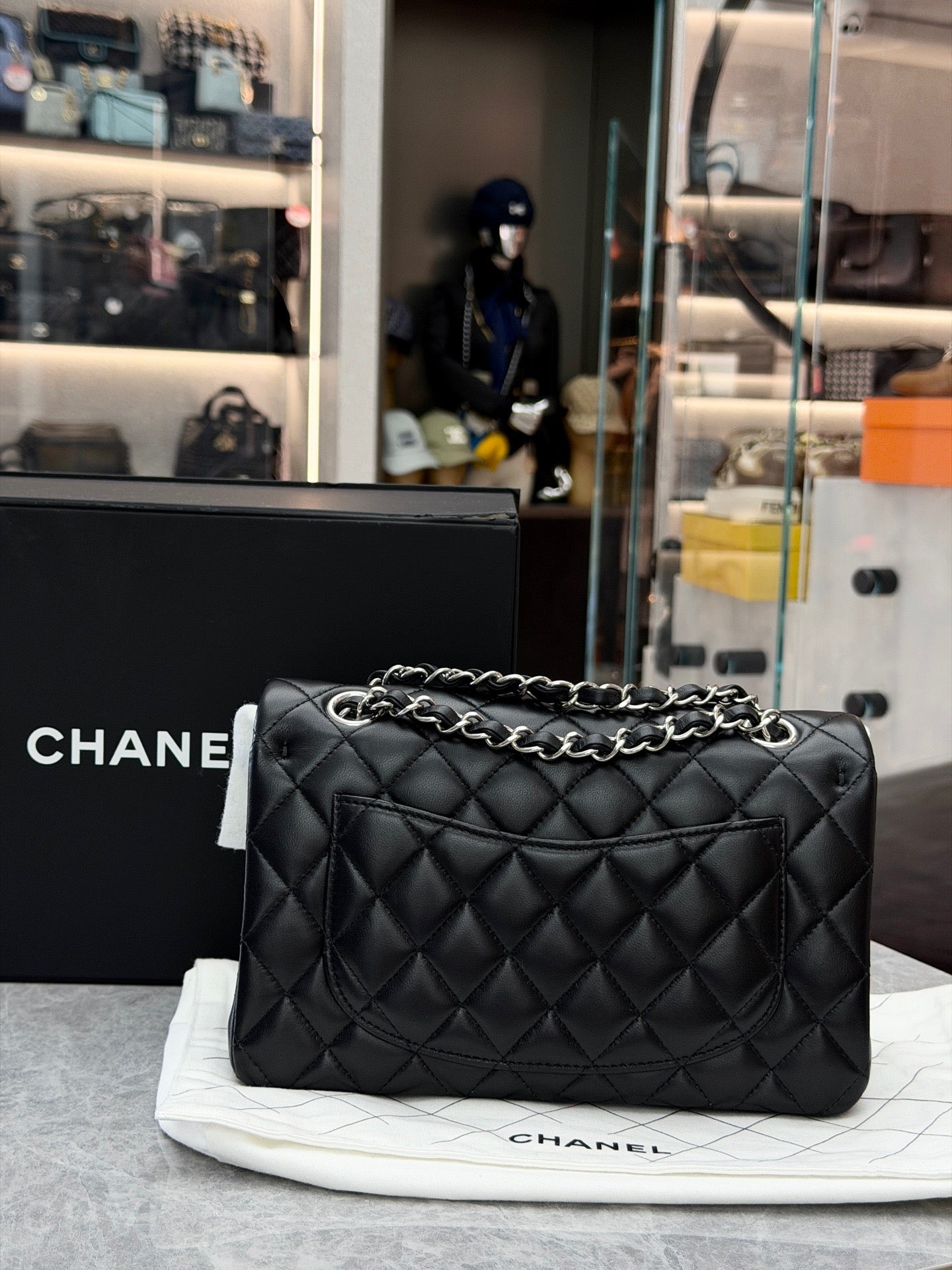 Chanel Classic Double Flap bag is crafted from black diamond-quilted lambskin leather and features silver-tone hardware