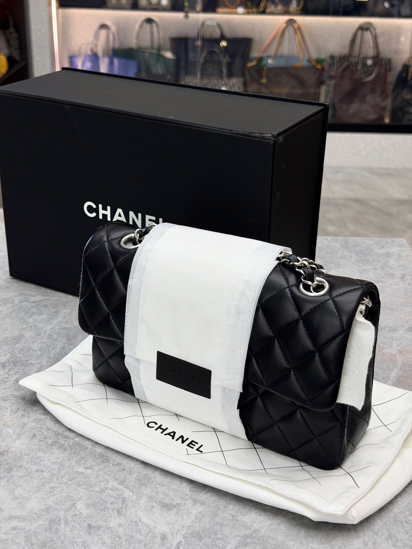 Chanel Classic Double Flap bag is crafted from black diamond-quilted lambskin leather and features silver-tone hardware