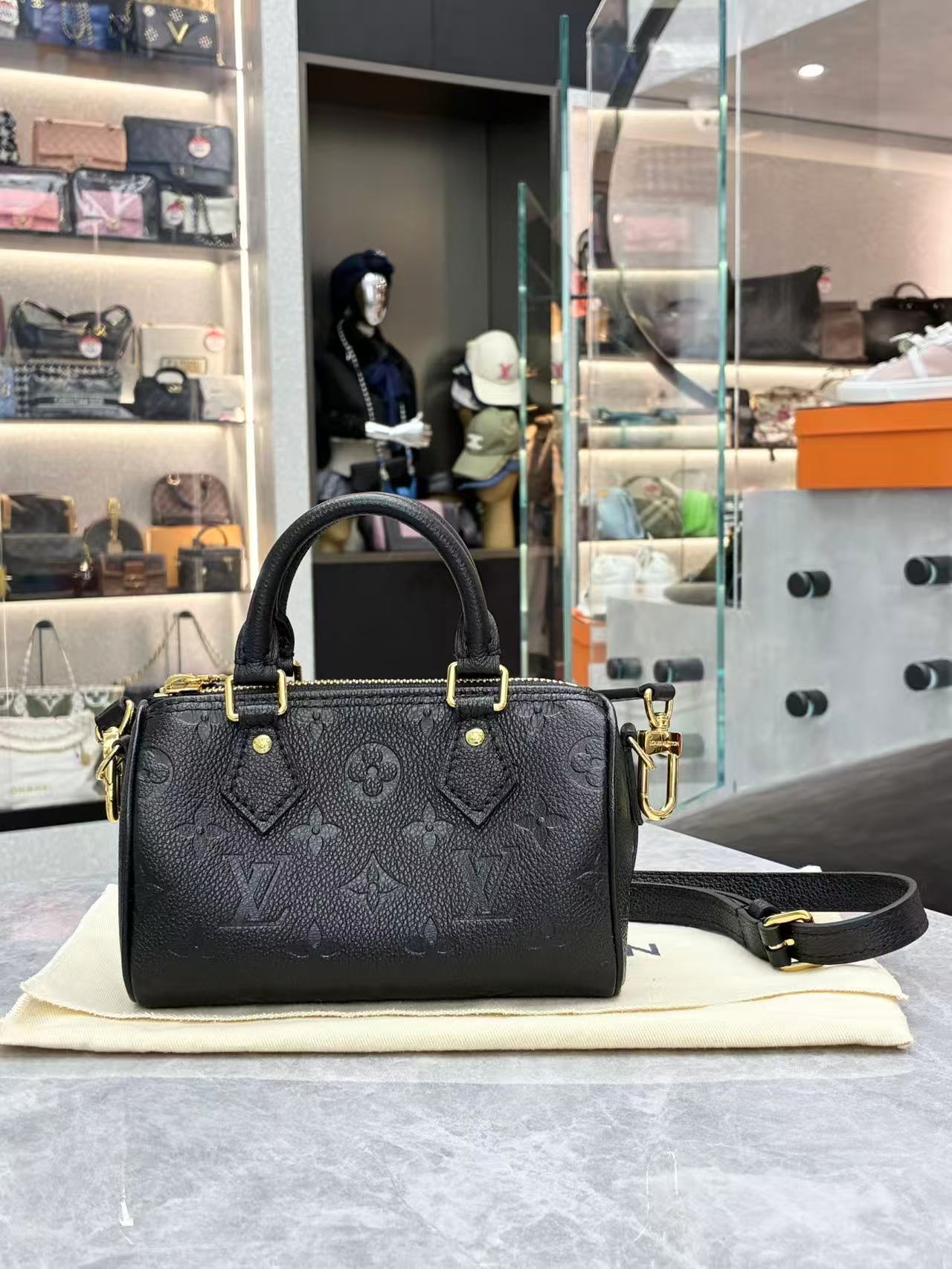 Louis Vuitton Nano Speedy bag featuring black embossed Monogram Empreinte leather and gold-tone hardware