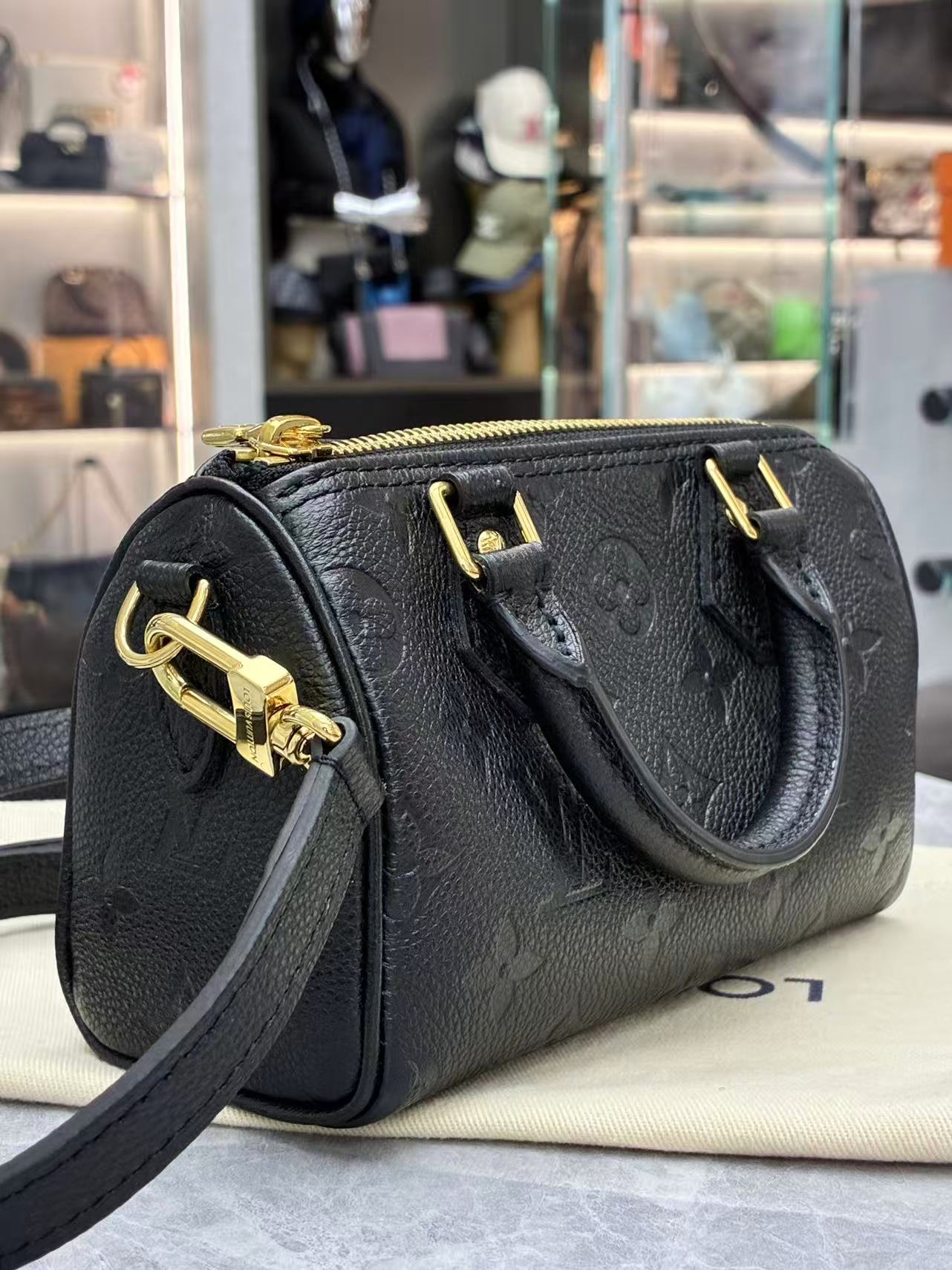 Louis Vuitton Nano Speedy bag featuring black embossed Monogram Empreinte leather and gold-tone hardware