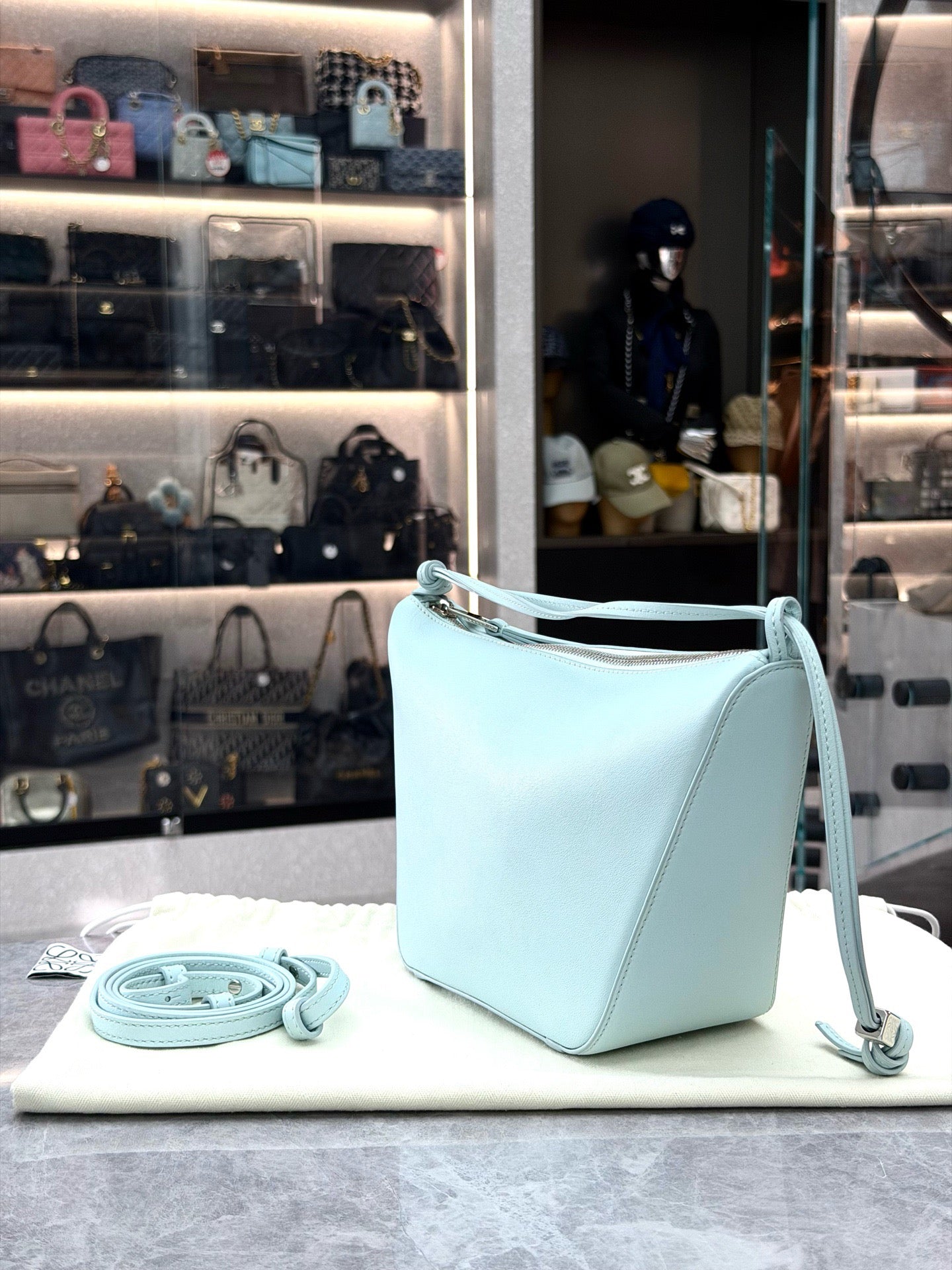 Loewe Mini Hammock Hobo bag features a distinct curved shape crafted from light blue calfskin leather
