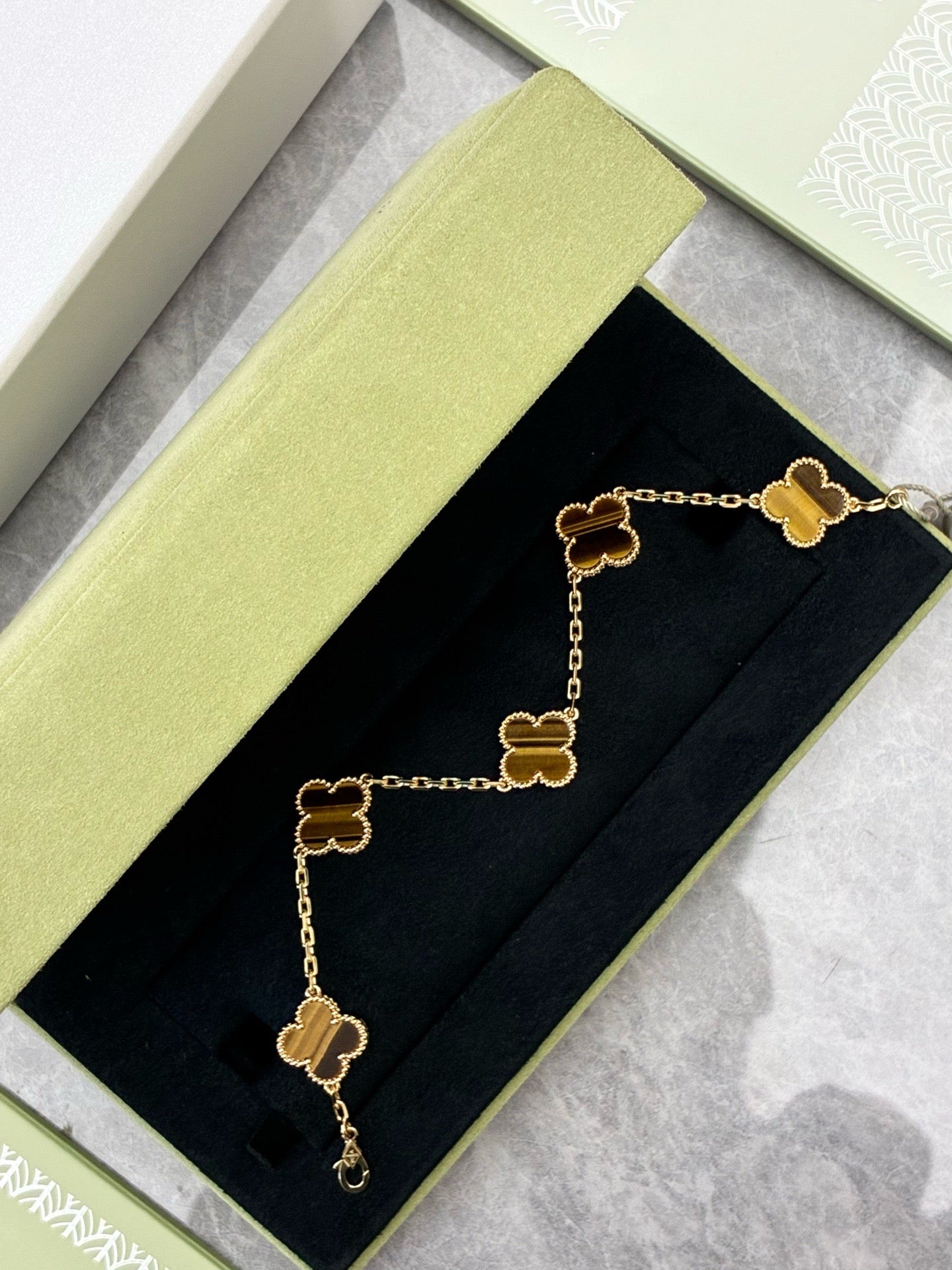 This Van Cleef & Arpels Vintage Alhambra bracelet features five motifs (tiger eye set in 18K yellow gold)