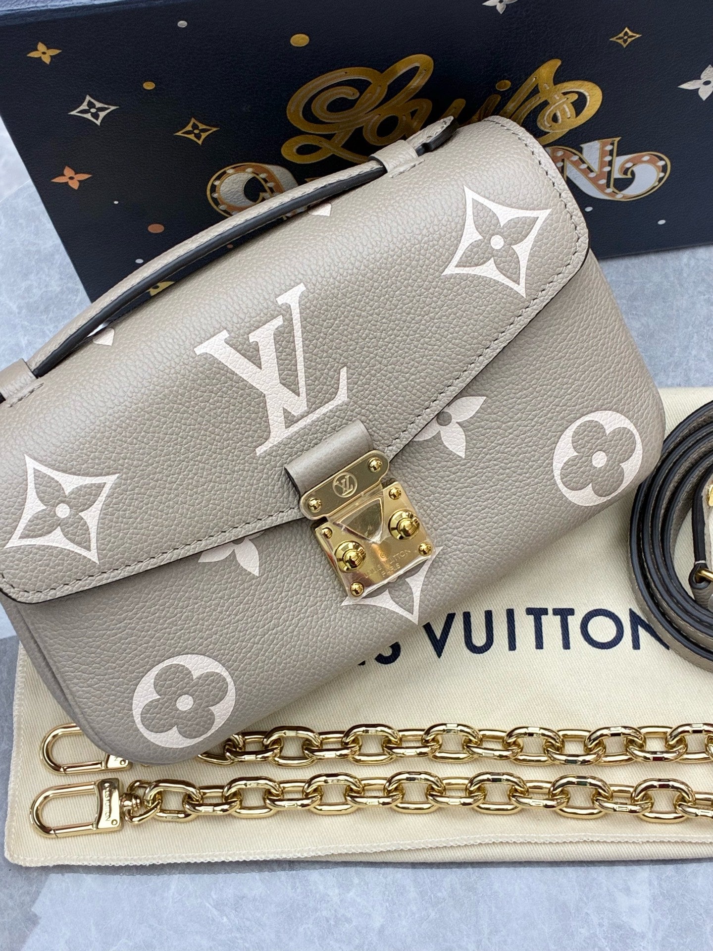 LOUIS VUITTON Pochette Métis East West – Elephant Grey Monogram Empreinte, Gold Hardware, Brand New