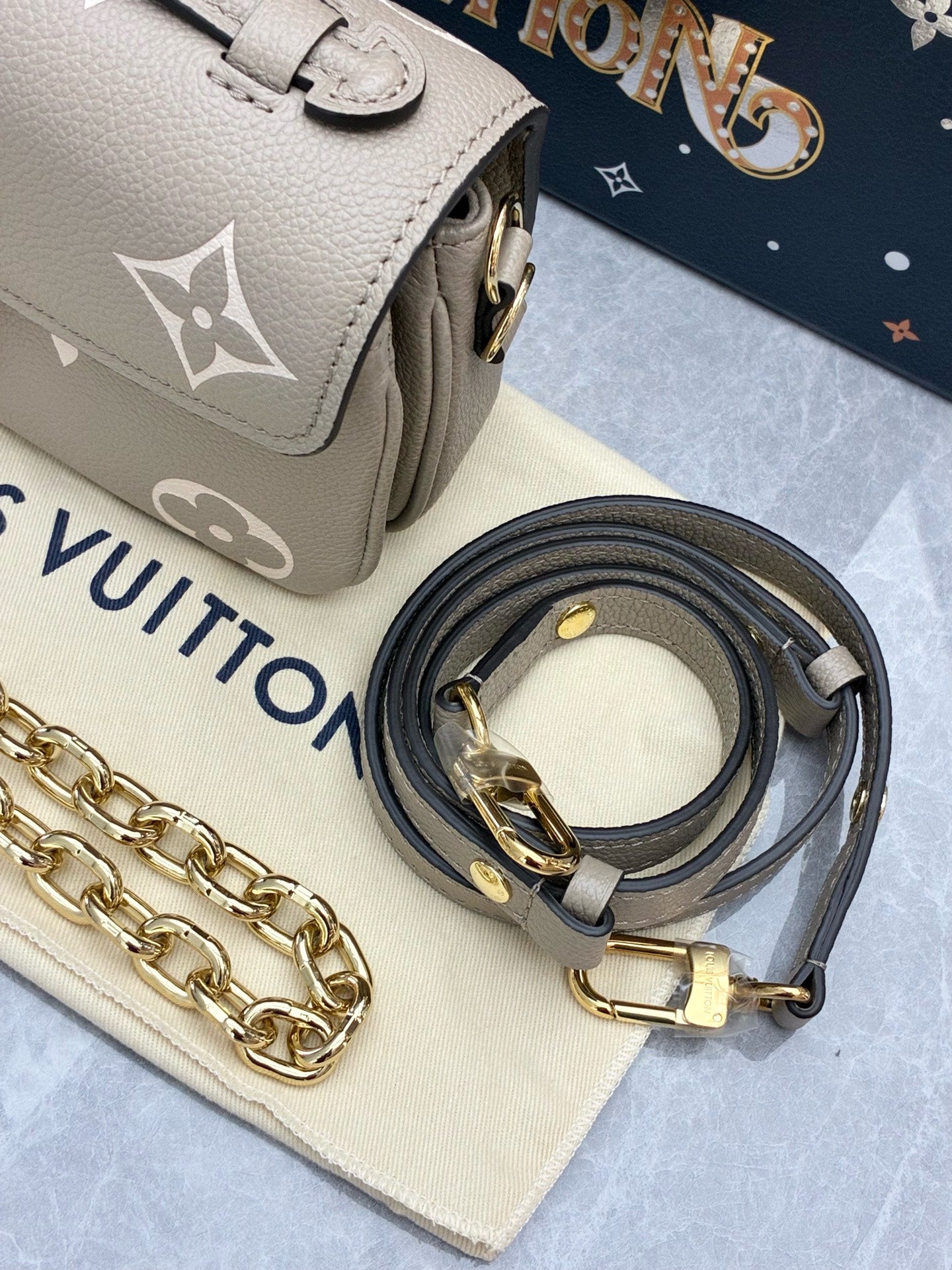 LOUIS VUITTON Pochette Métis East West – Elephant Grey Monogram Empreinte, Gold Hardware, Brand New