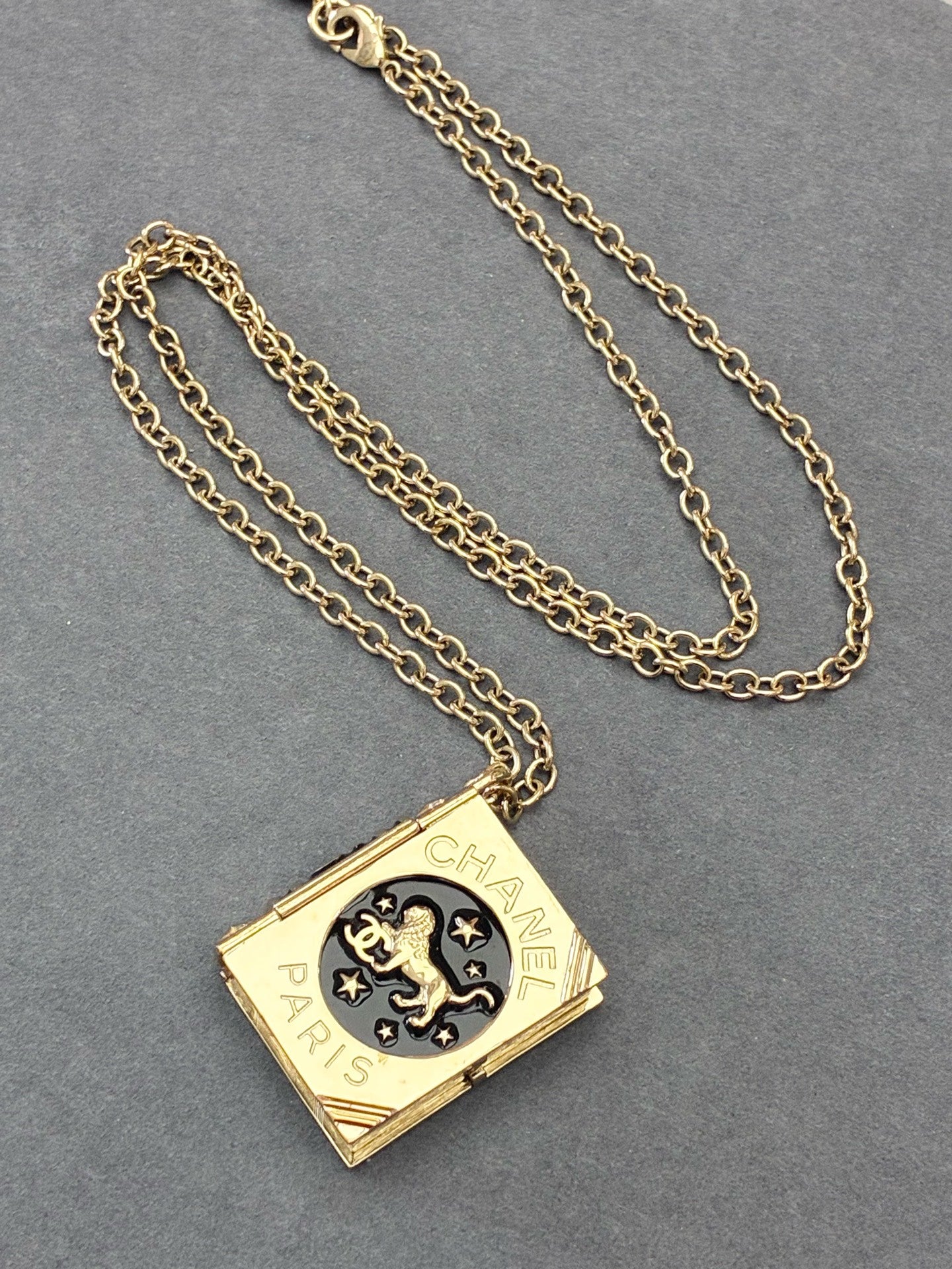 CHANEL Lion Spellbook Necklace – Gold-Tone Metal, Lion & CC Motif, Very Good Pre-Owned