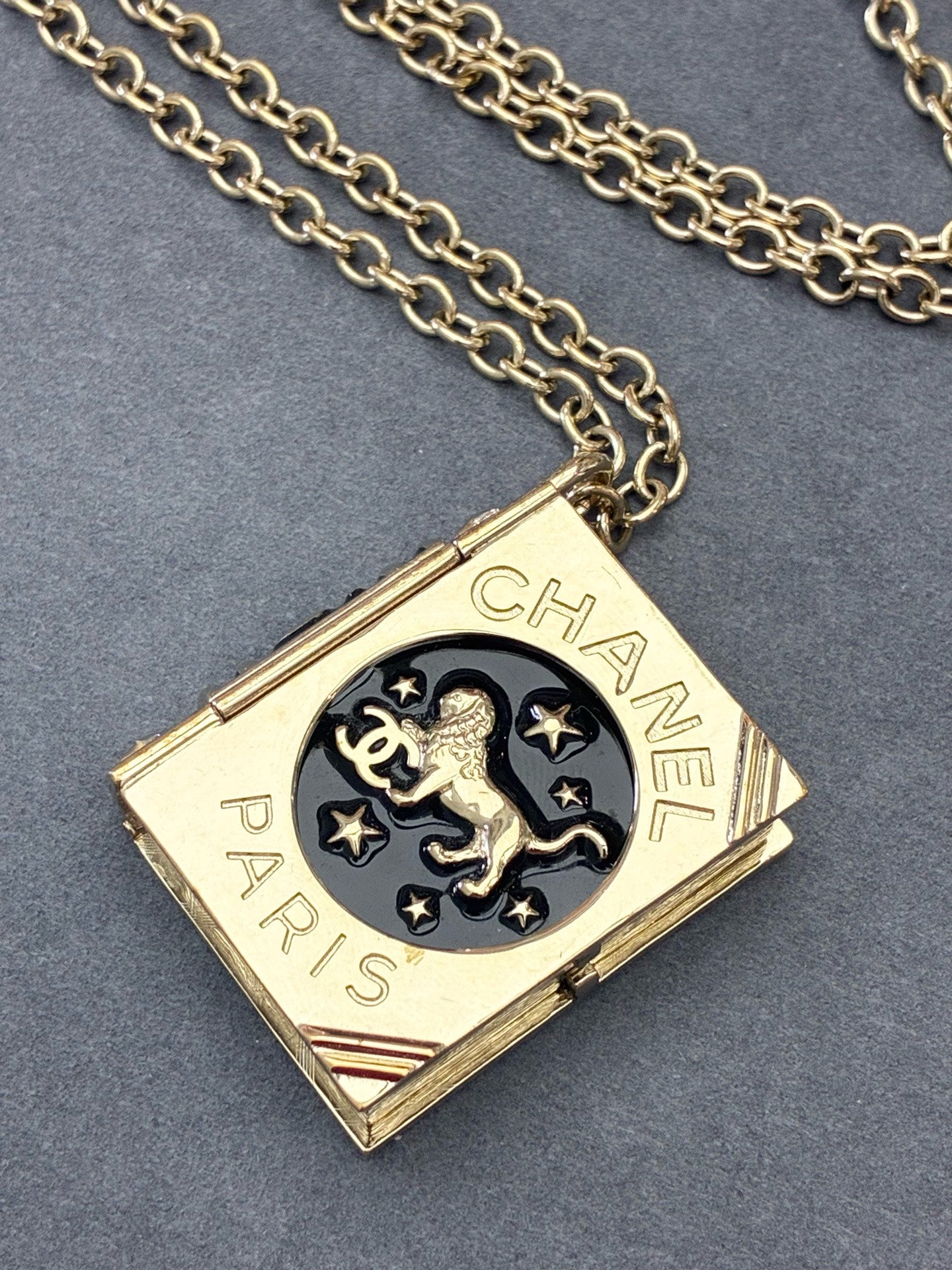 CHANEL Lion Spellbook Necklace – Gold-Tone Metal, Lion & CC Motif, Very Good Pre-Owned