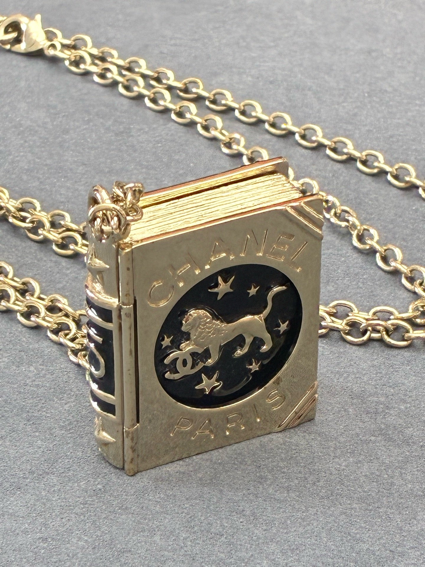 CHANEL Lion Spellbook Necklace – Gold-Tone Metal, Lion & CC Motif, Very Good Pre-Owned