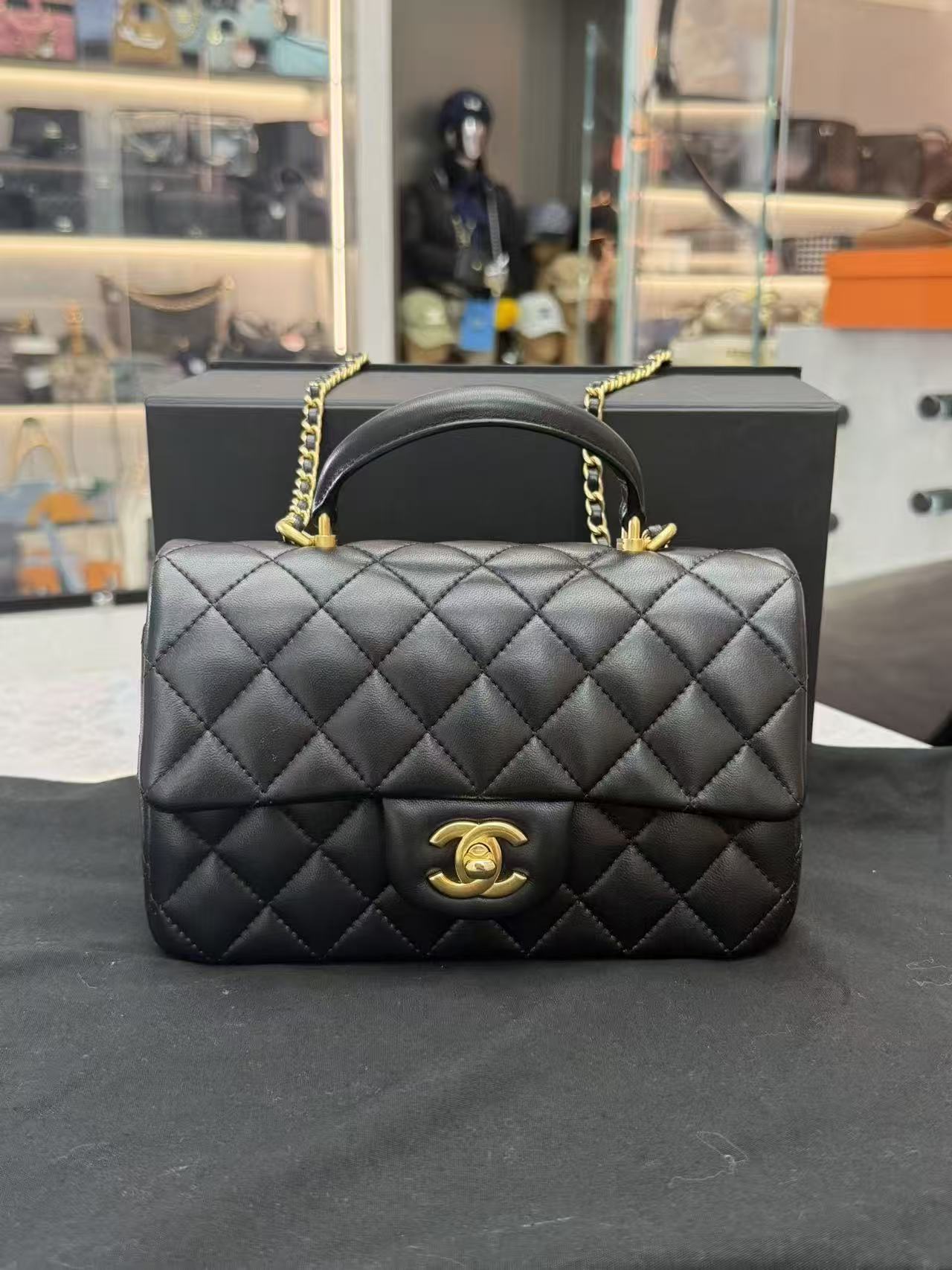 Chanel Top Handle Mini Rectangular Flap Bag in black lambskin leather with antique gold hardware