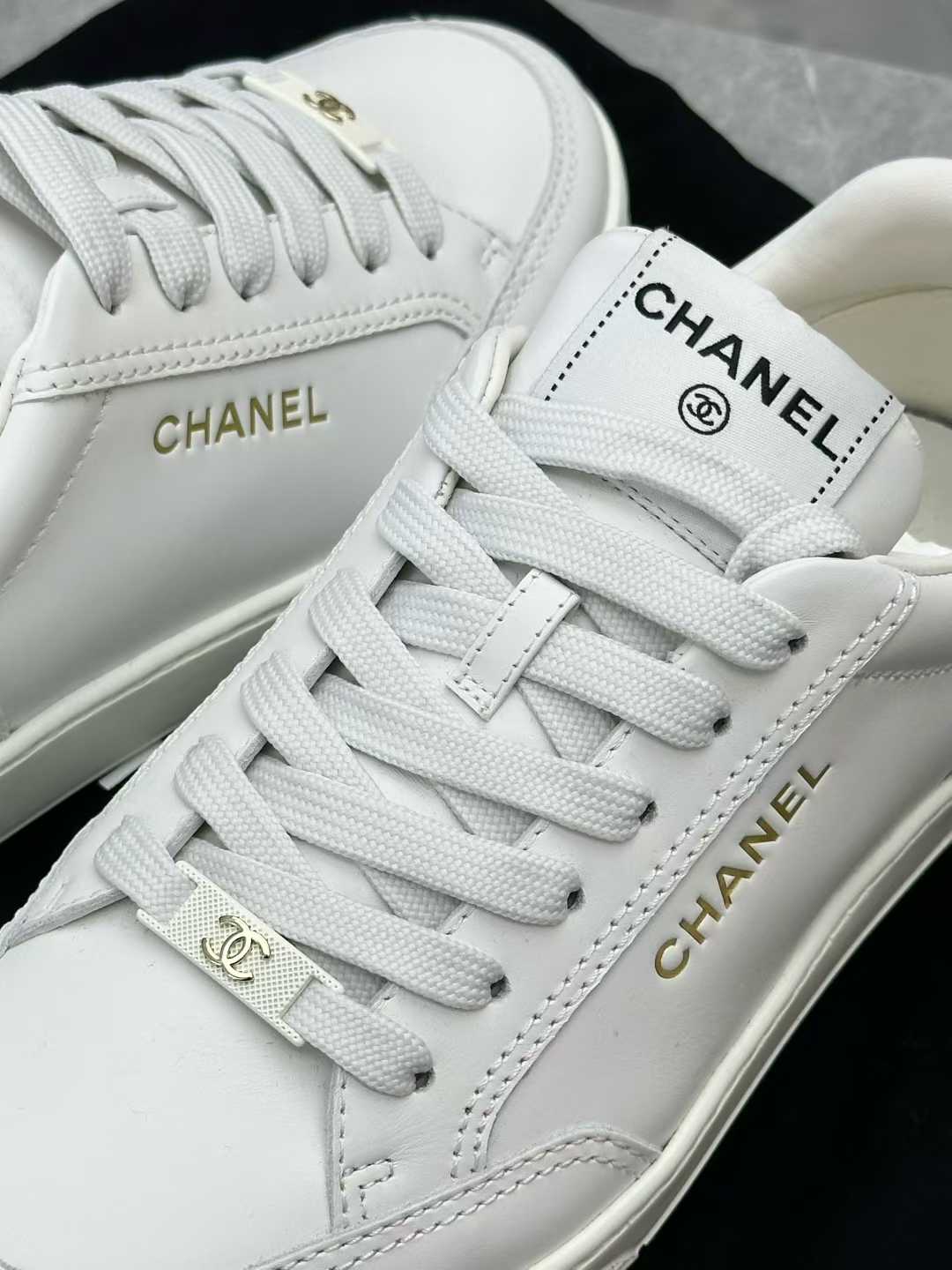 Chanel white calfskin sneakers, identified as style G45085 from the 23S collection, size 37
