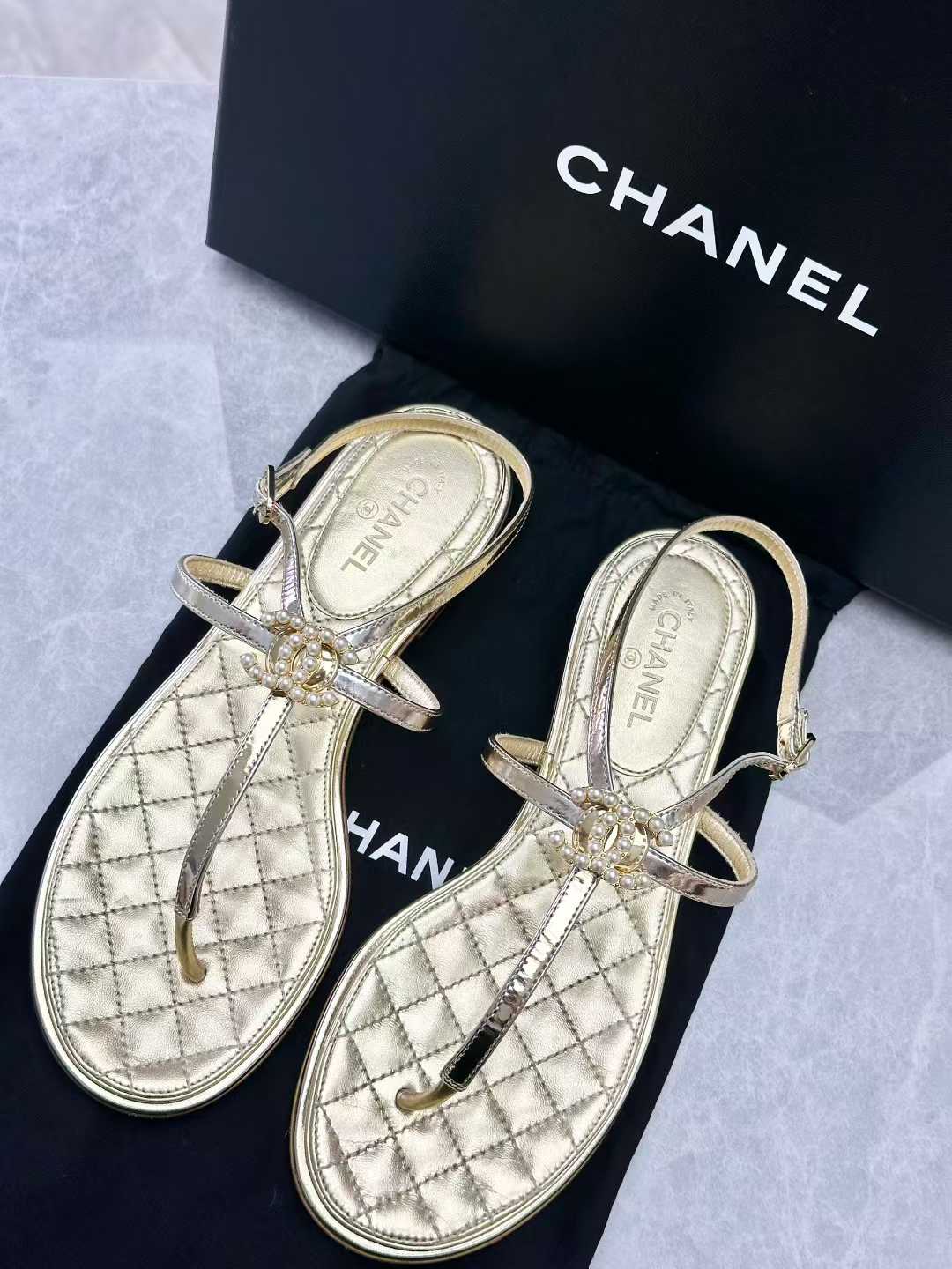 Chanel gold leather thong sandals, featuring a quilted insole and a CC logo with pearl details on the T-strap, size36C