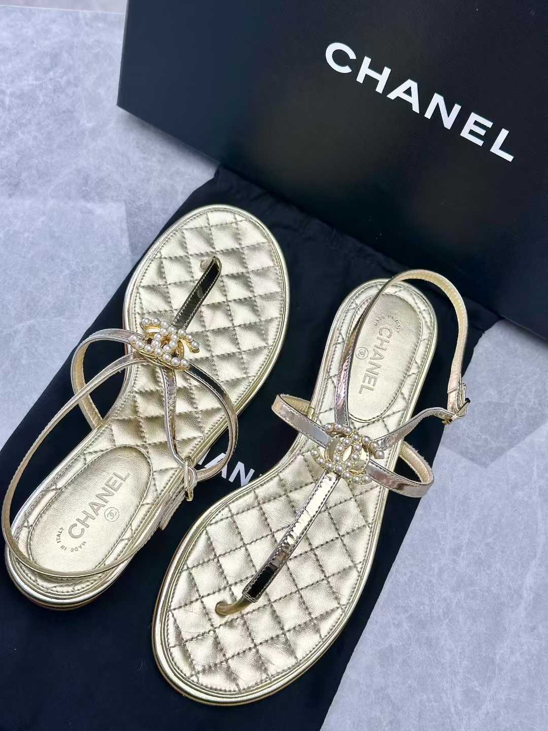 Chanel gold leather thong sandals, featuring a quilted insole and a CC logo with pearl details on the T-strap, size36C