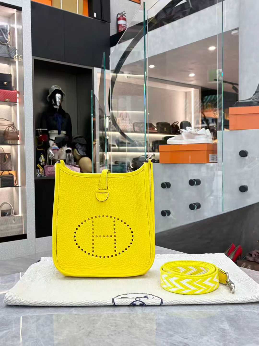 Hermès Evelyne TPM mini crossbody bag in Lime or Limoncello Clemence leather with palladium hardware