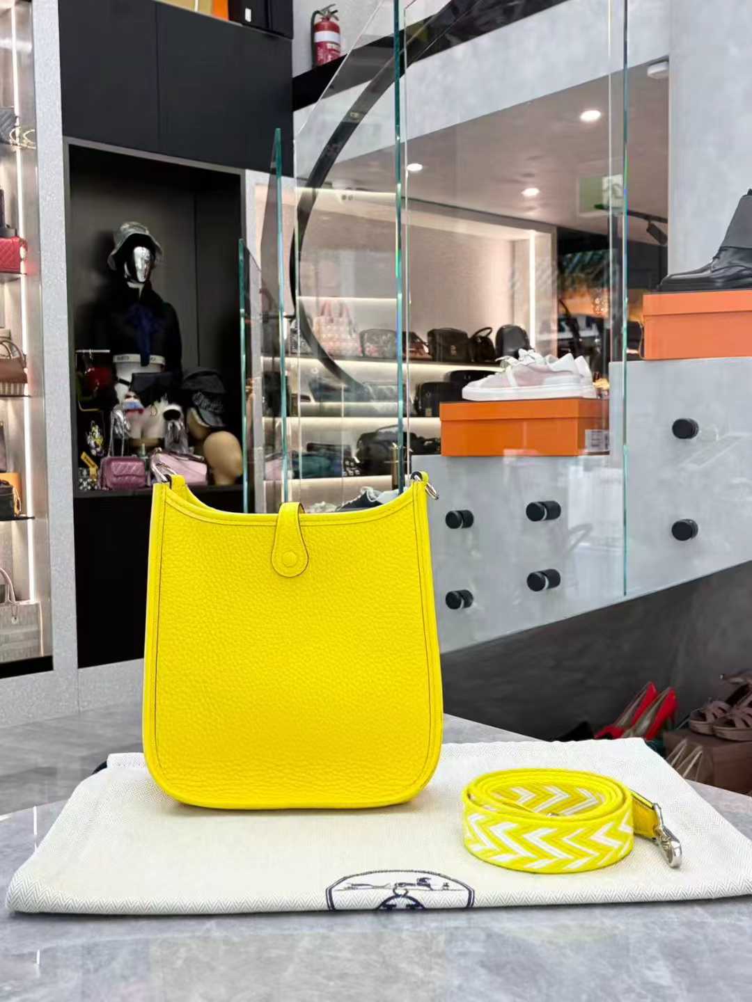 Hermès Evelyne TPM mini crossbody bag in Lime or Limoncello Clemence leather with palladium hardware