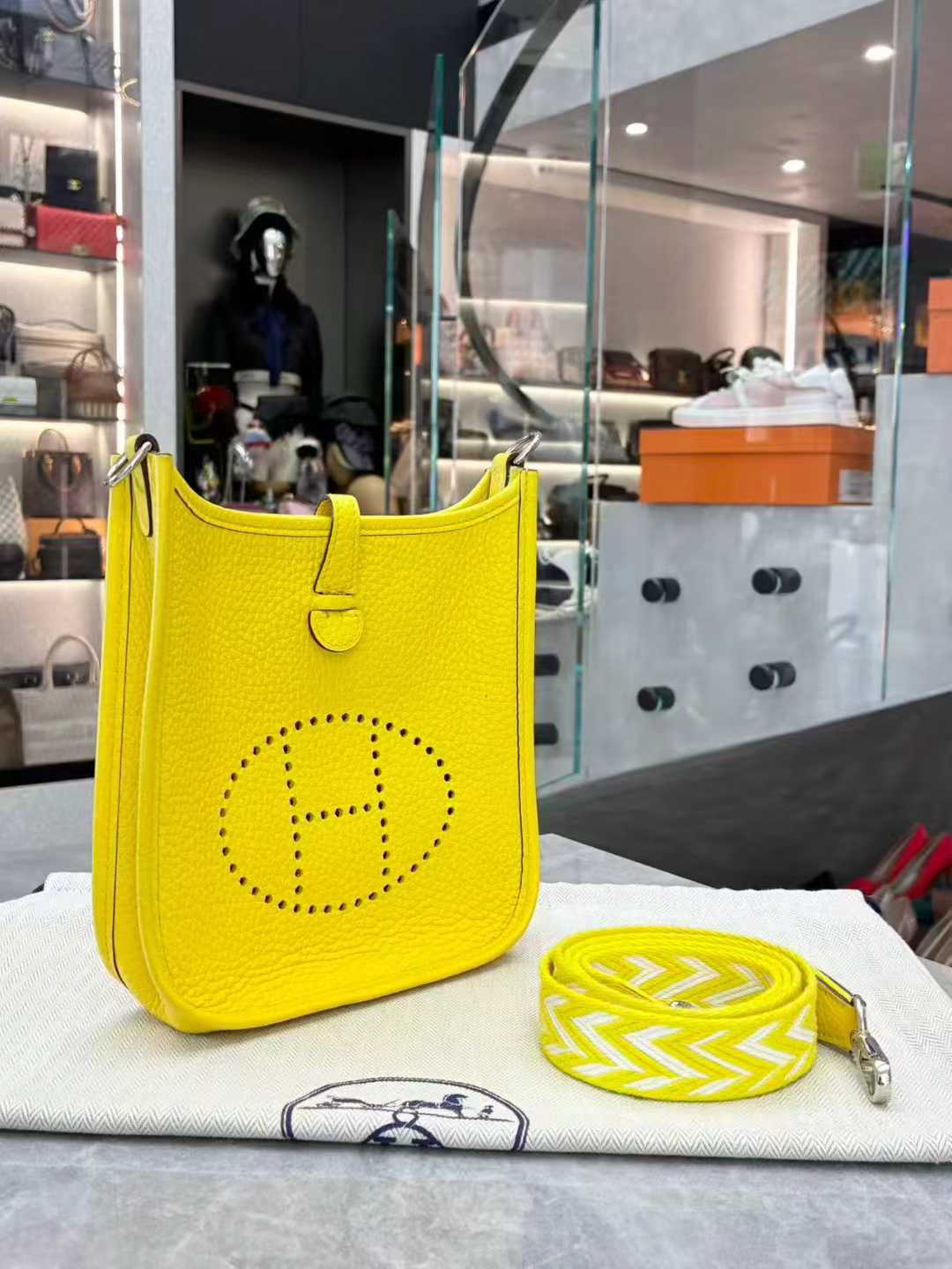 Hermès Evelyne TPM mini crossbody bag in Lime or Limoncello Clemence leather with palladium hardware