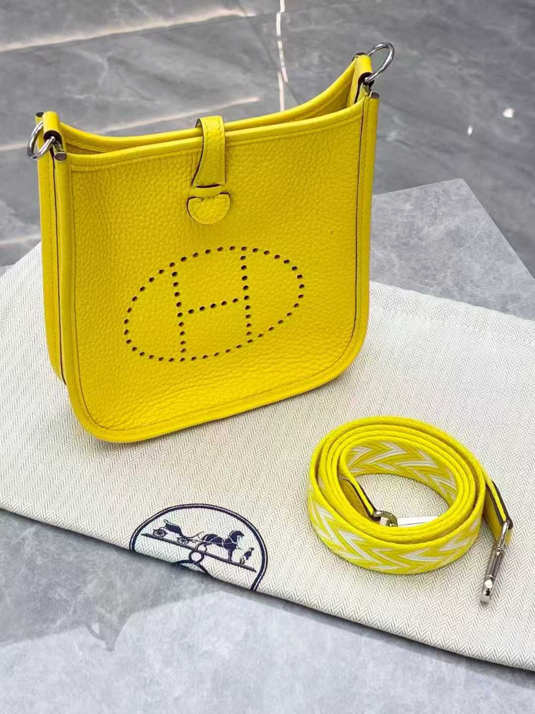 Hermès Evelyne TPM mini crossbody bag in Lime or Limoncello Clemence leather with palladium hardware