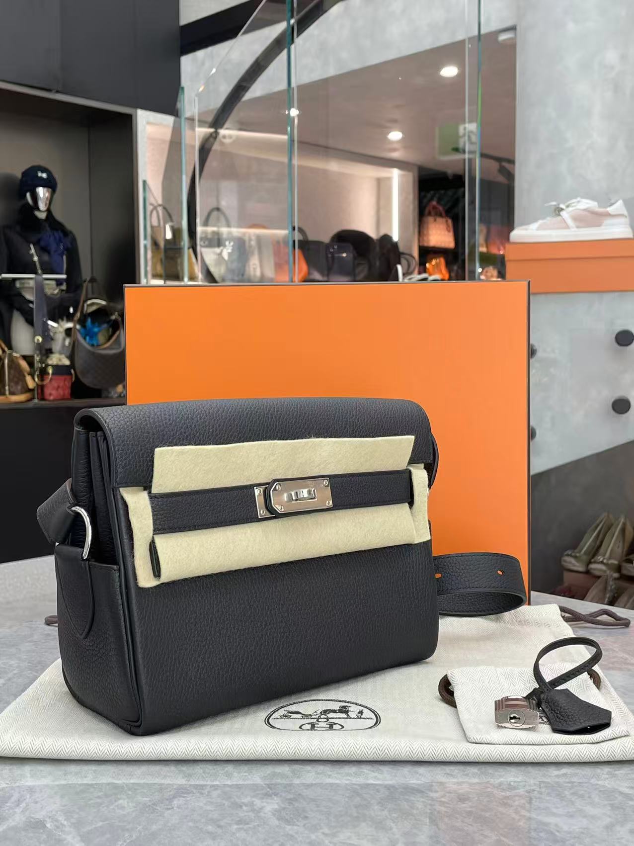 Hermès Kelly Black Messenger PM bag crafted from Togo leather with palladium-plated hardware