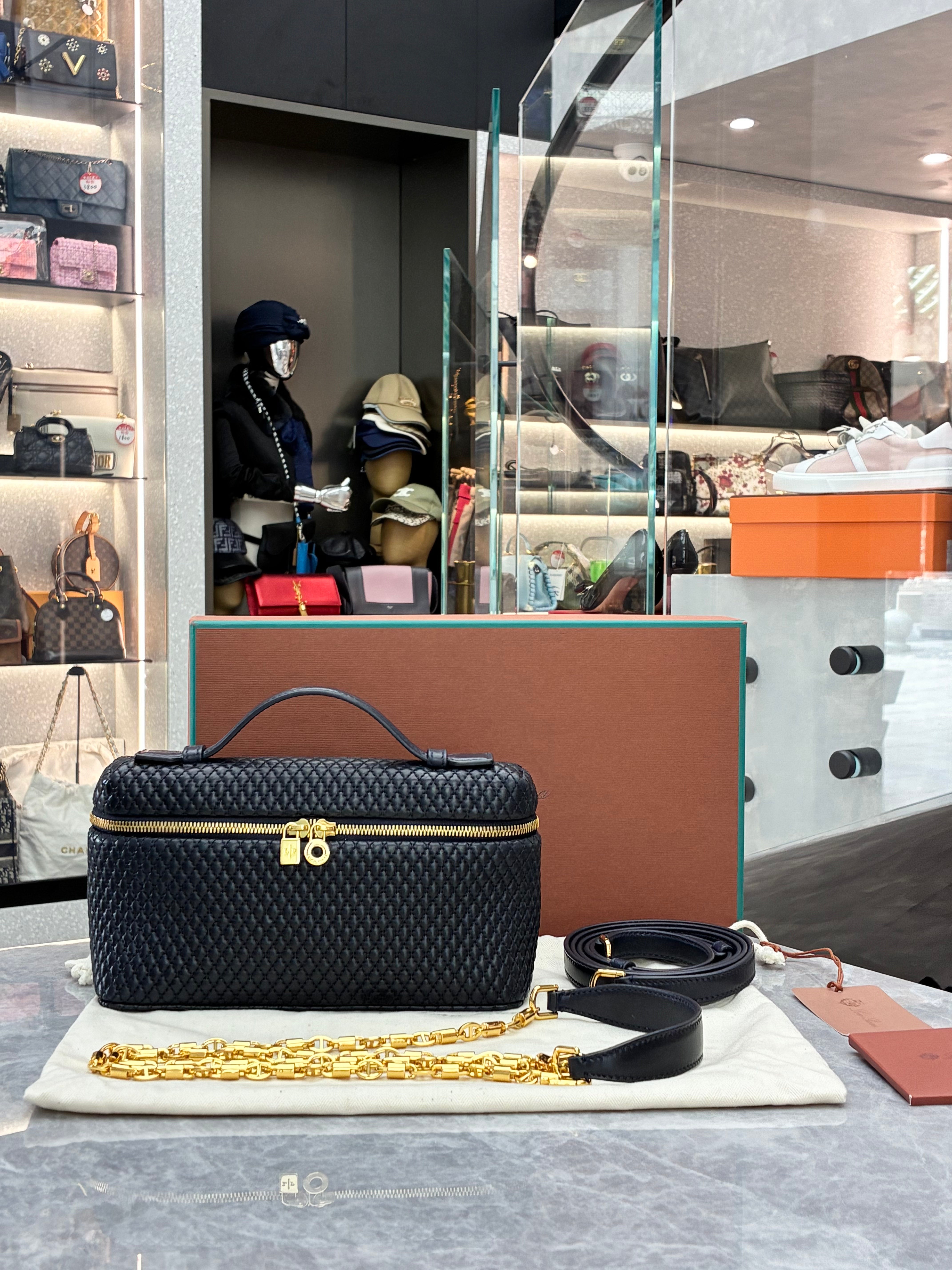 Loro Piana Extra Pocket L19 quilted leather pouch, featuring a structured silhouette with top handle and detachable strap