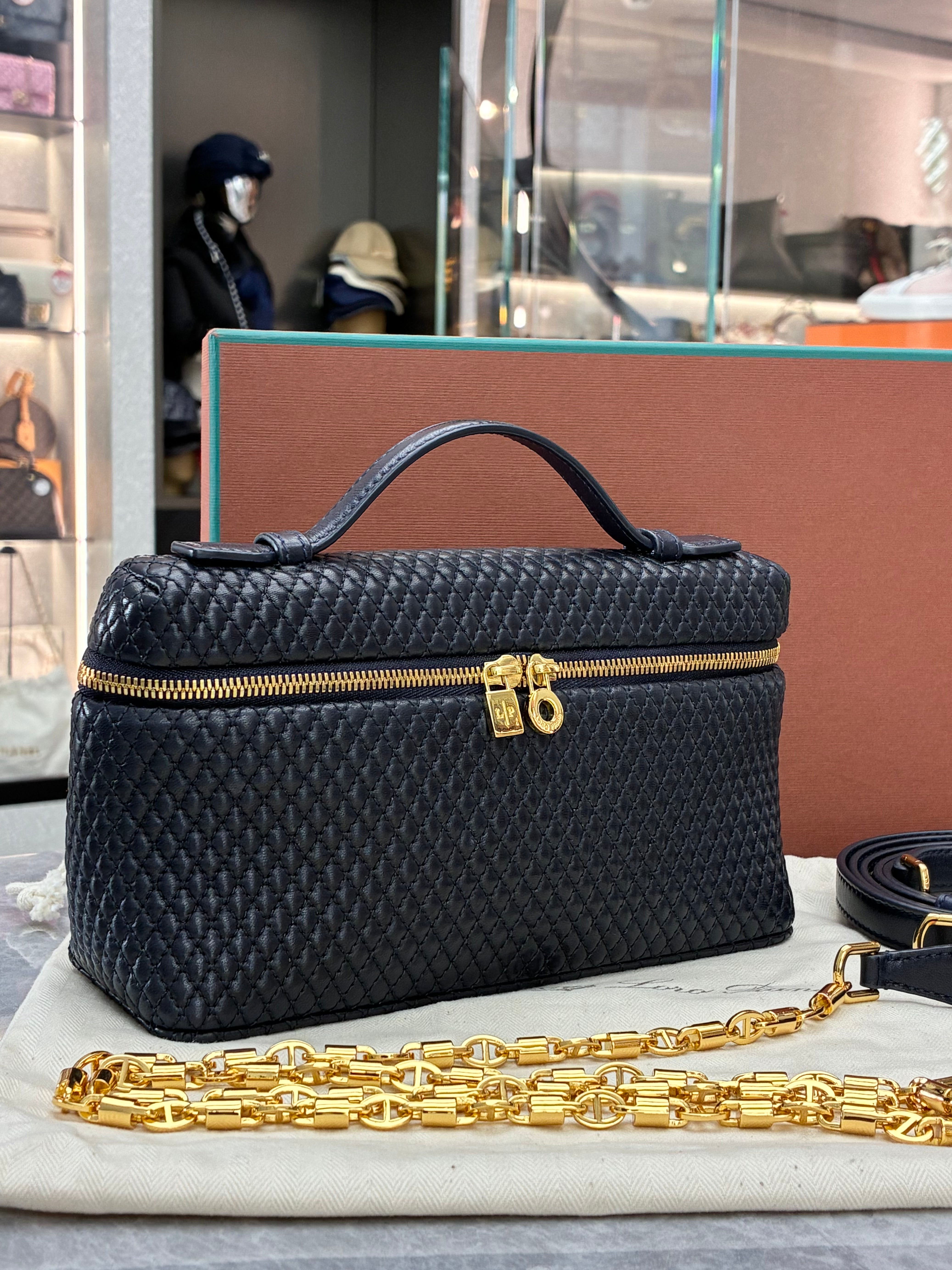 Loro Piana Extra Pocket L19 quilted leather pouch, featuring a structured silhouette with top handle and detachable strap