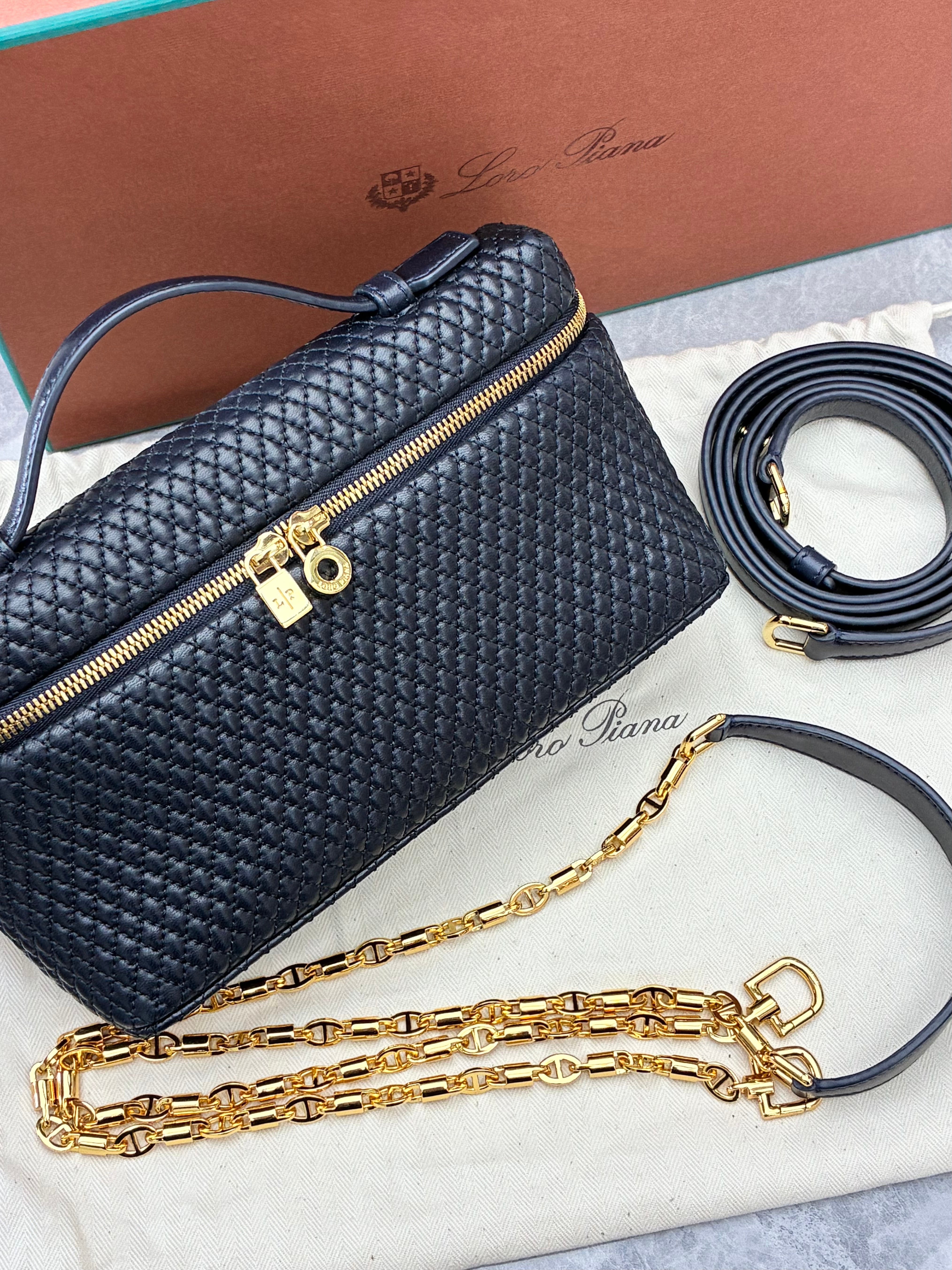 Loro Piana Extra Pocket L19 quilted leather pouch, featuring a structured silhouette with top handle and detachable strap