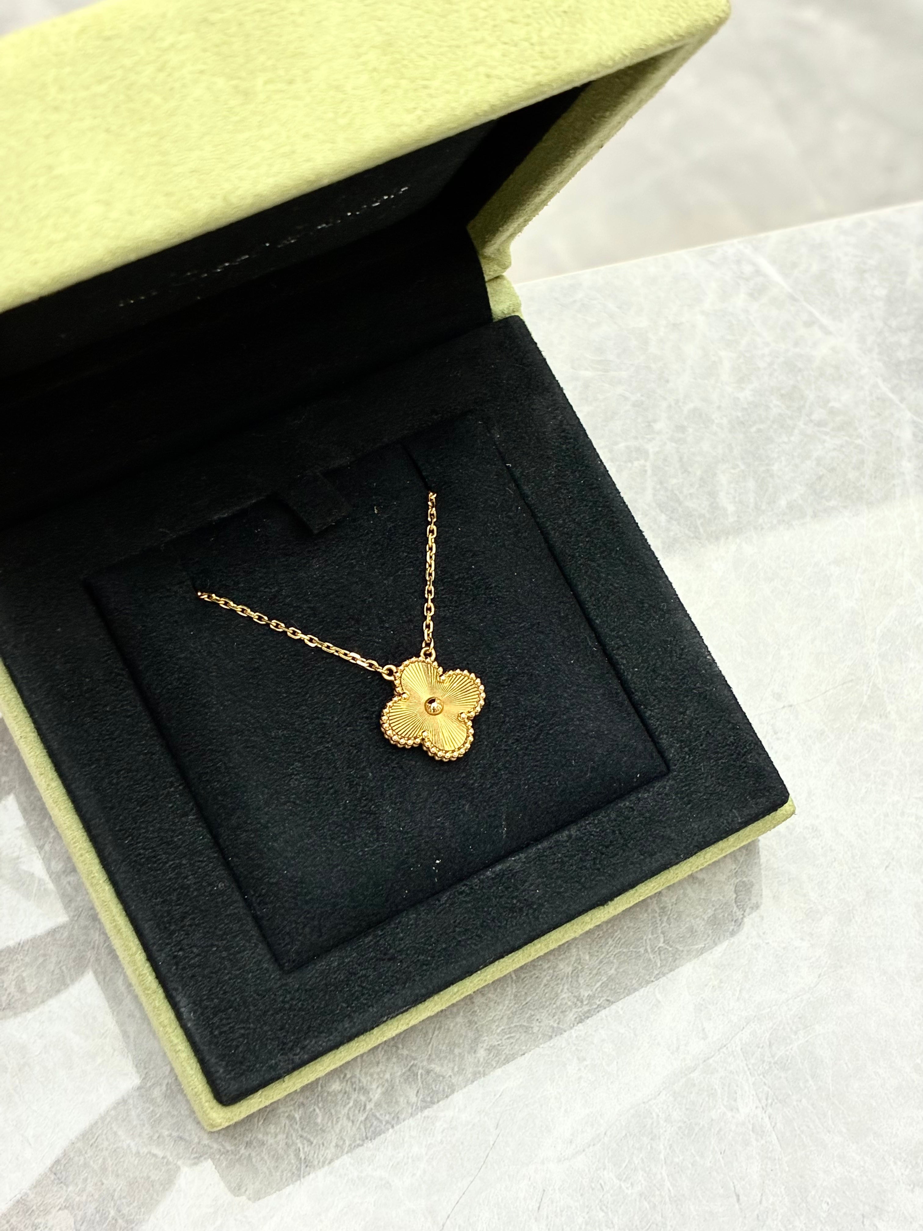 Van Cleef & Arpels Vintage Alhambra pendant necklace features a clover motif crafted in 18K yellow gold with a guilloché pattern