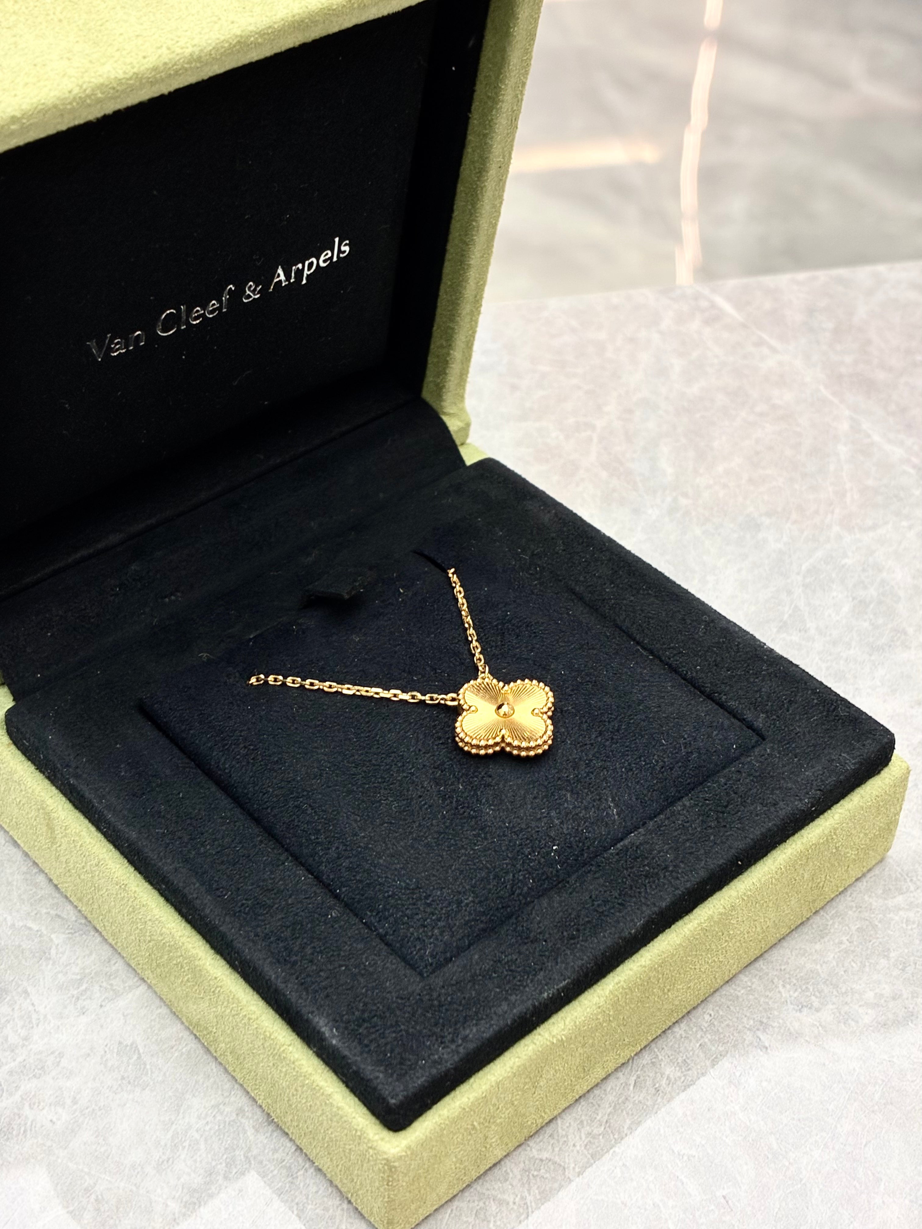 Van Cleef & Arpels Vintage Alhambra pendant necklace features a clover motif crafted in 18K yellow gold with a guilloché pattern