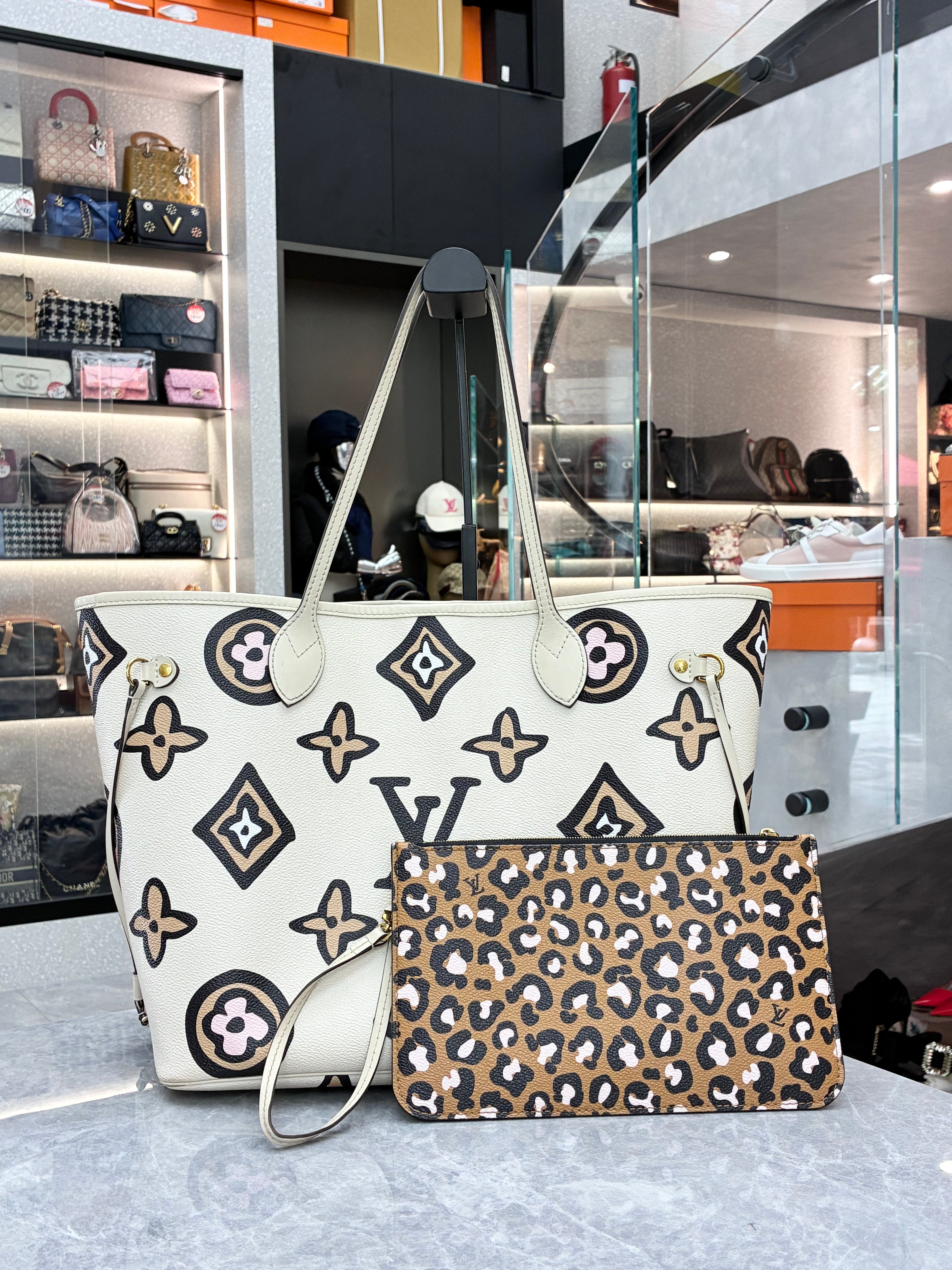 Louis Vuitton Neverfull MM tote bag from the 2021 Fall "Wild at Heart" capsule collection, featuring a cream monogram print with a leopard-print zipped pouch