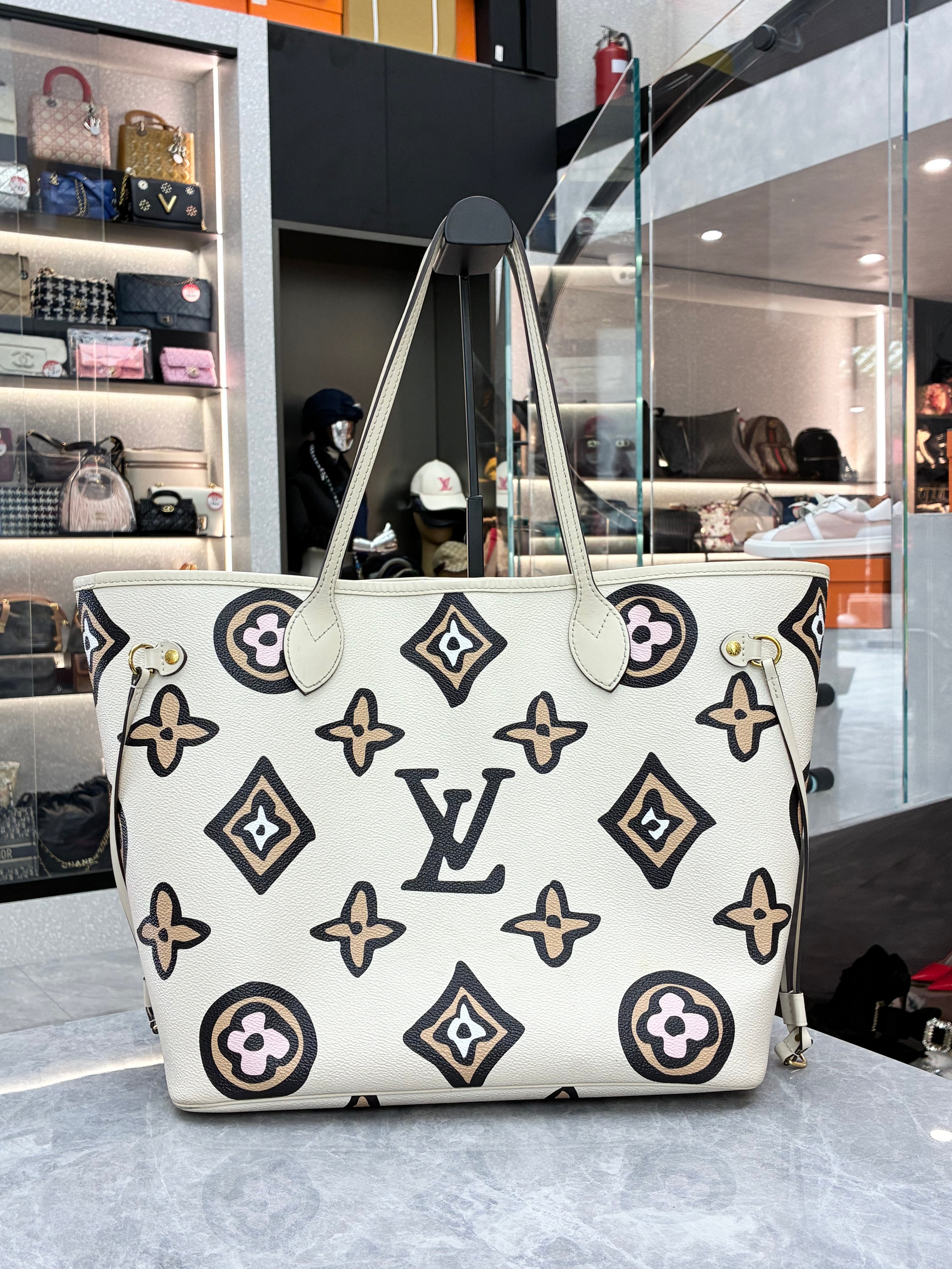 Louis Vuitton Neverfull MM tote bag from the 2021 Fall "Wild at Heart" capsule collection, featuring a cream monogram print with a leopard-print zipped pouch