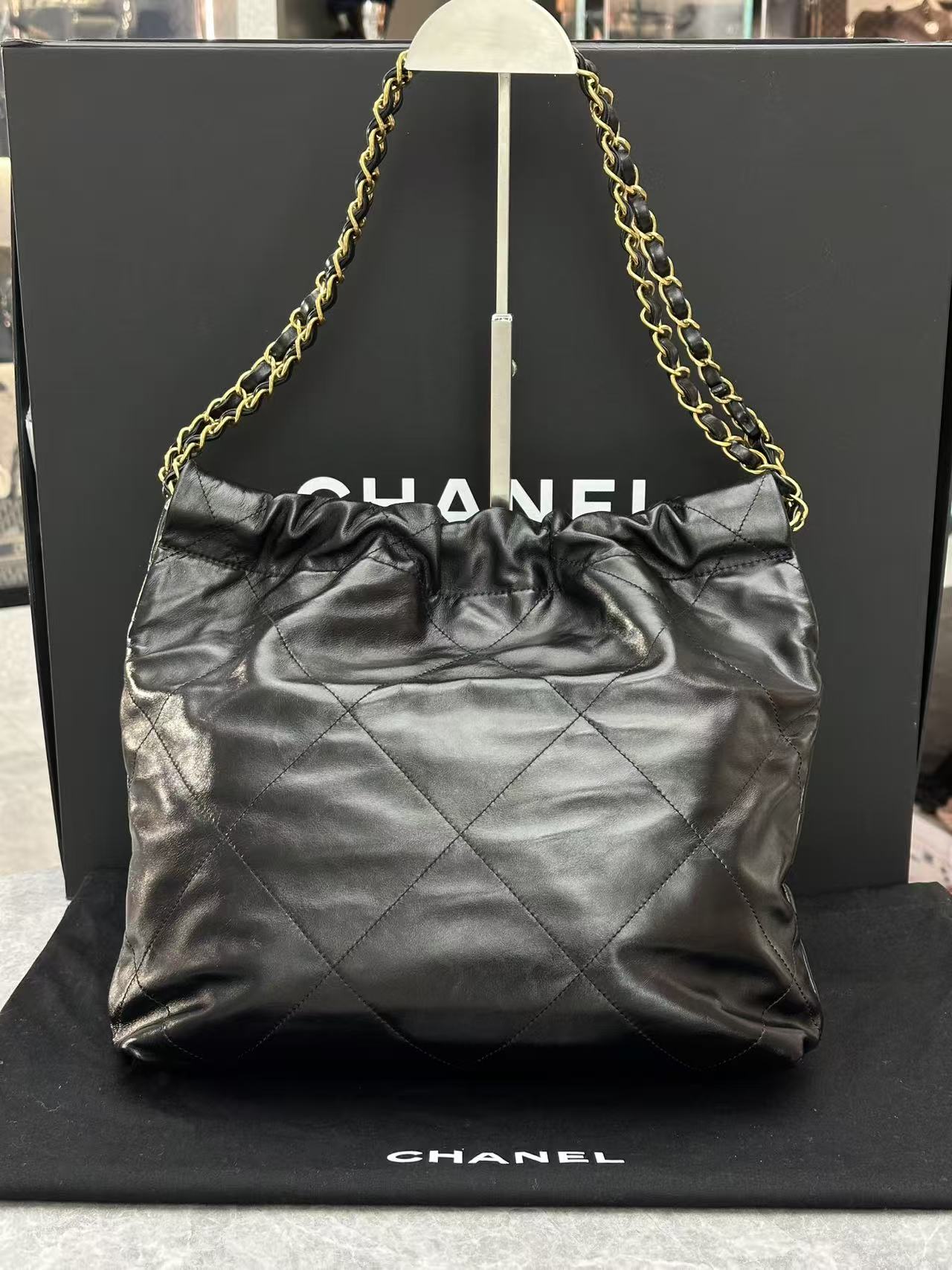 Chanel black 22 handbag crafted from shiny calfskin leather and gold-tone hardware 