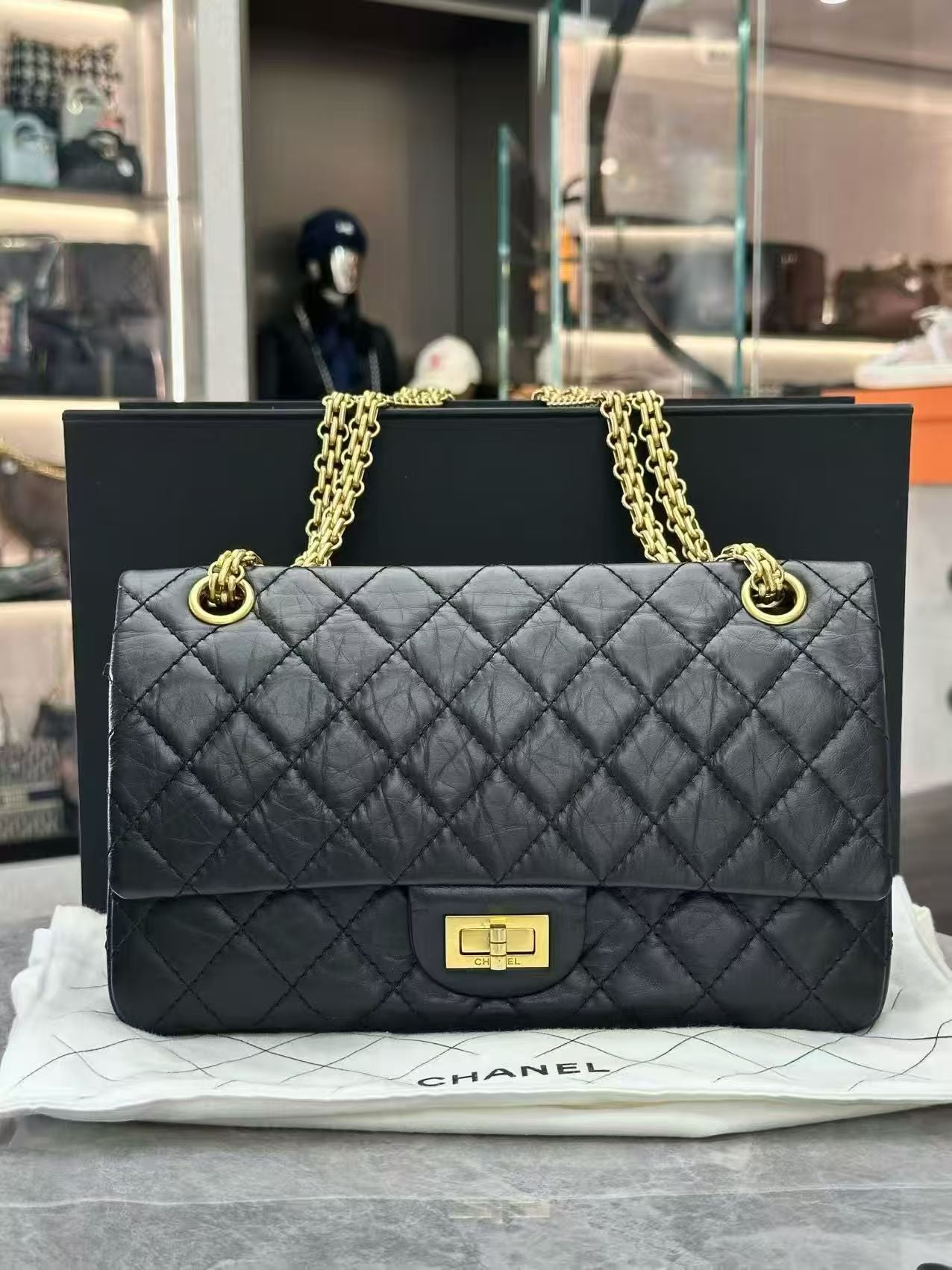 Chanel 2.55 Reissue flap handbag, crafted from black aged calfskin leather and featuring gold-tone hardware