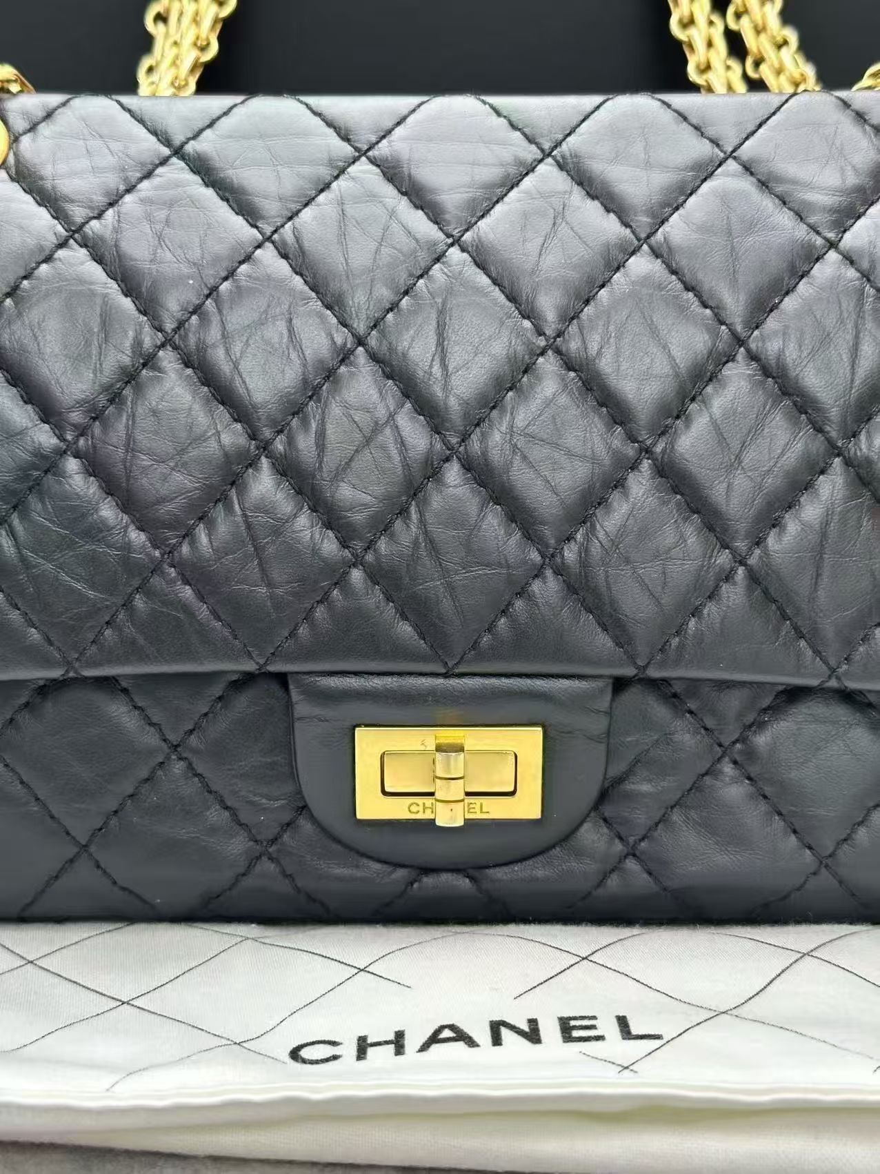 Chanel 2.55 Reissue flap handbag, crafted from black aged calfskin leather and featuring gold-tone hardware