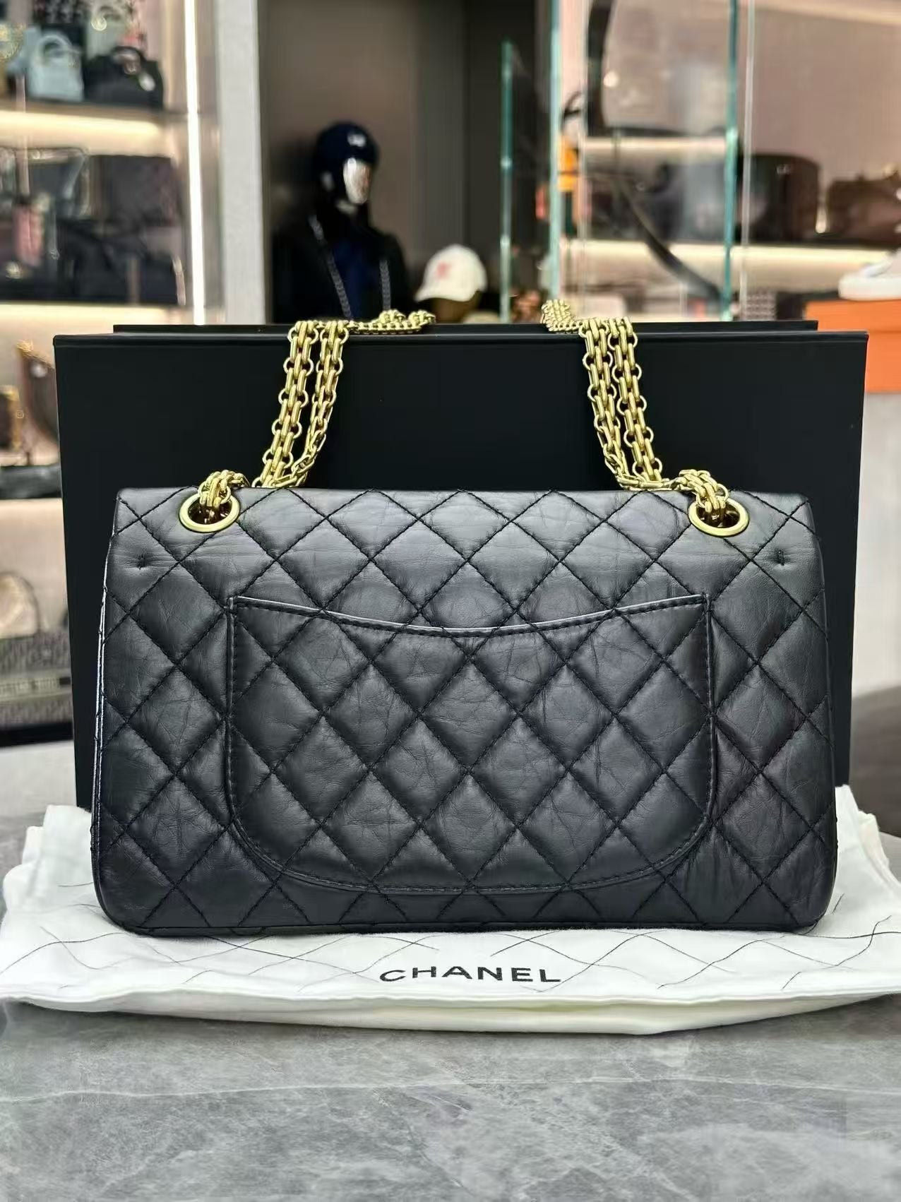 Chanel 2.55 Reissue flap handbag, crafted from black aged calfskin leather and featuring gold-tone hardware