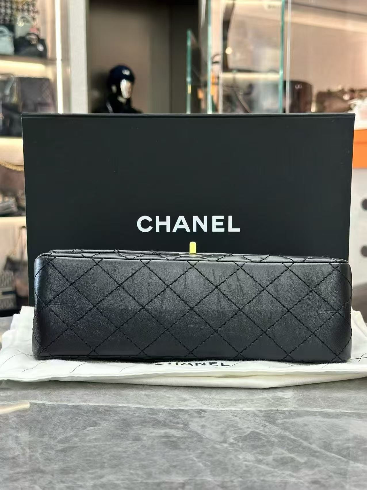 Chanel 2.55 Reissue flap handbag, crafted from black aged calfskin leather and featuring gold-tone hardware