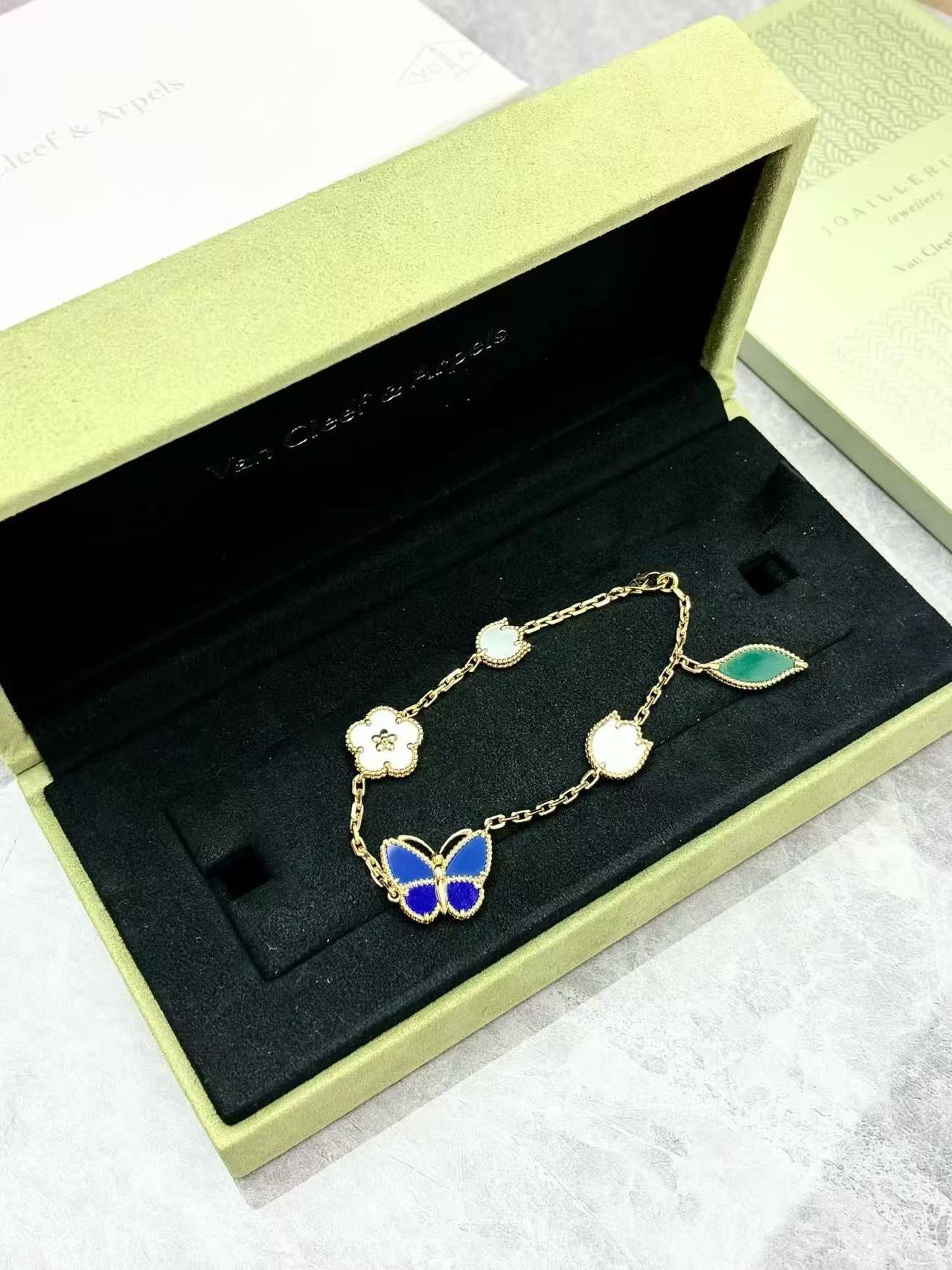 Van Cleef & Arpels Lucky Spring Butterfly bracelet in 18K yellow gold, featuring motifs made from white mother-of-pearl, onyx, lapis lazuli, and agate