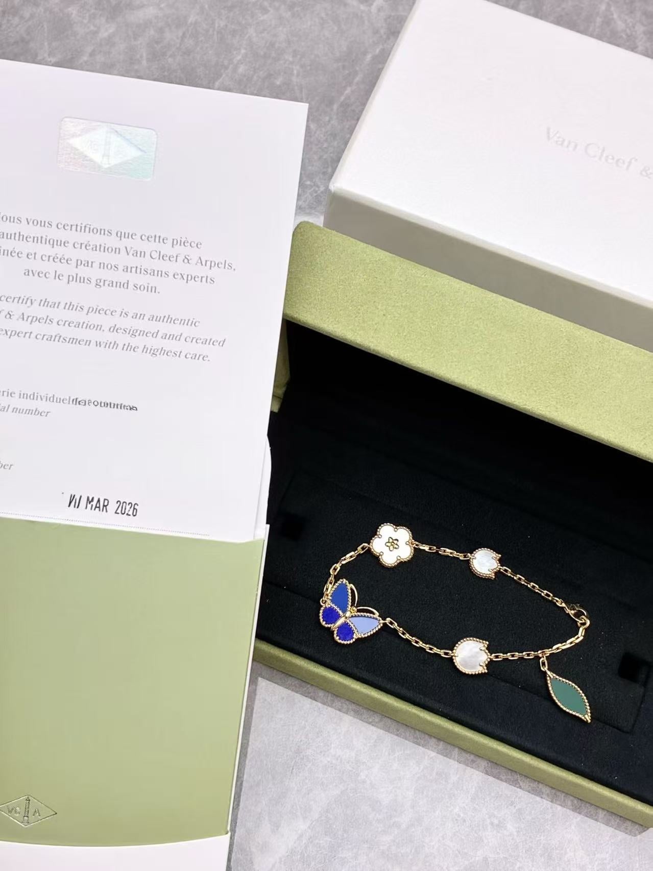Van Cleef & Arpels Lucky Spring Butterfly bracelet in 18K yellow gold, featuring motifs made from white mother-of-pearl, onyx, lapis lazuli, and agate