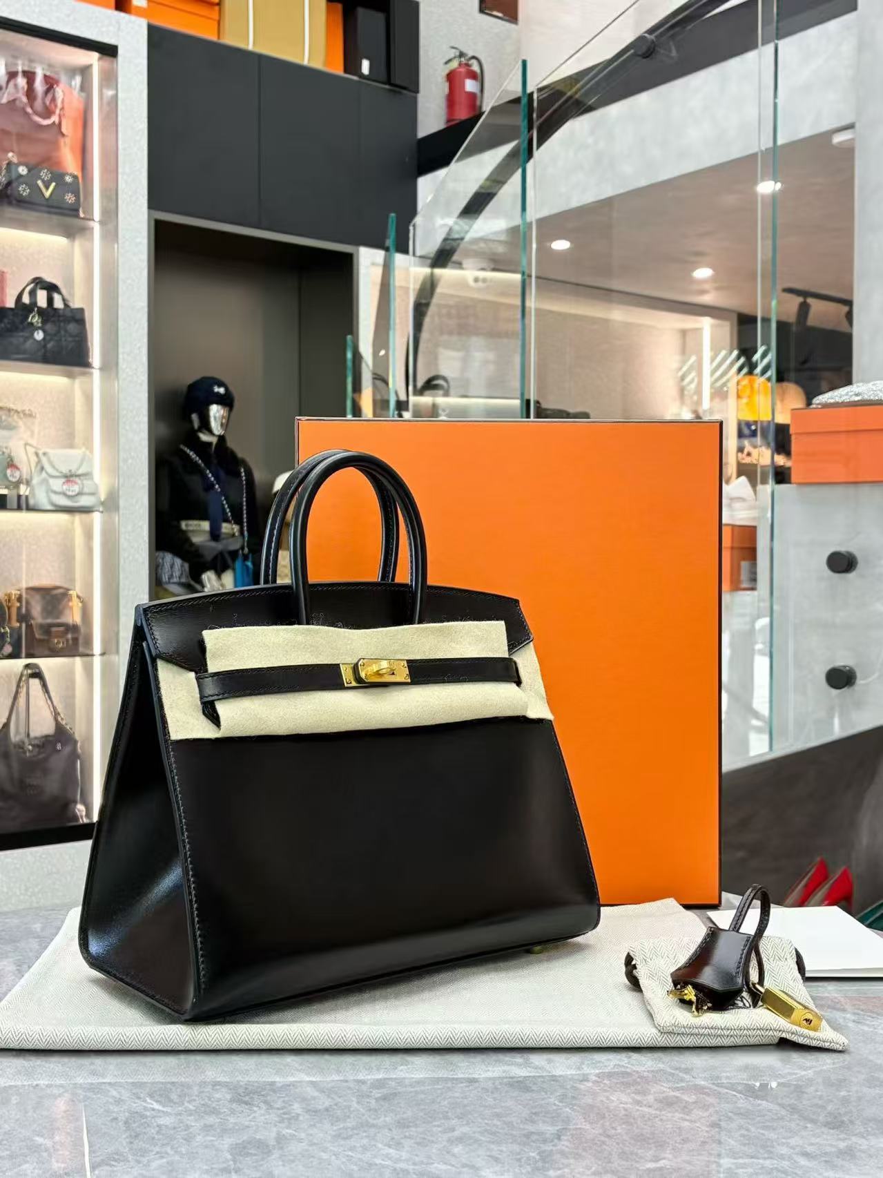 Hermès black Birkin 25 tote bag crafted from Veau Madame leather