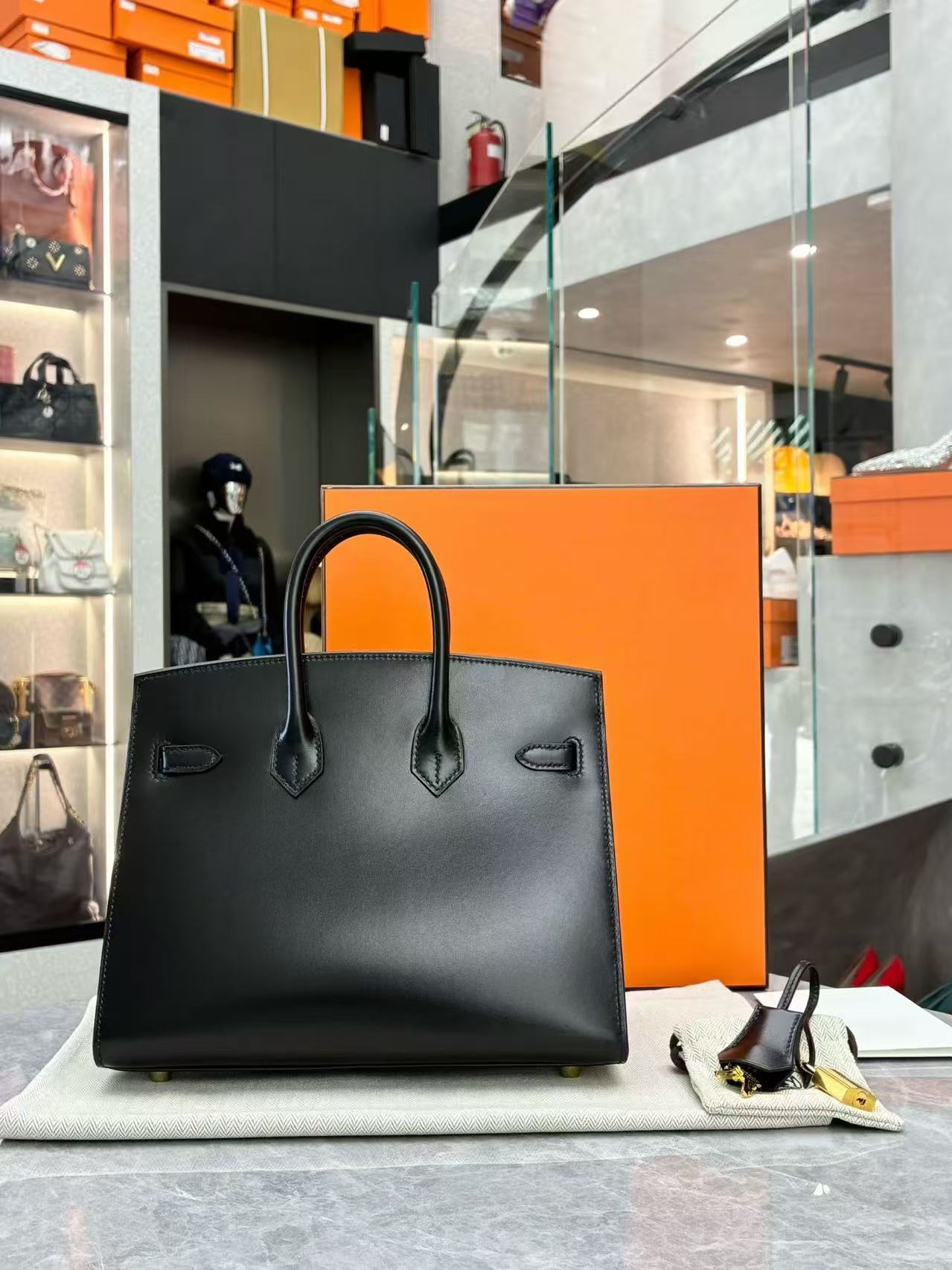 Hermès black Birkin 25 tote bag crafted from Veau Madame leather