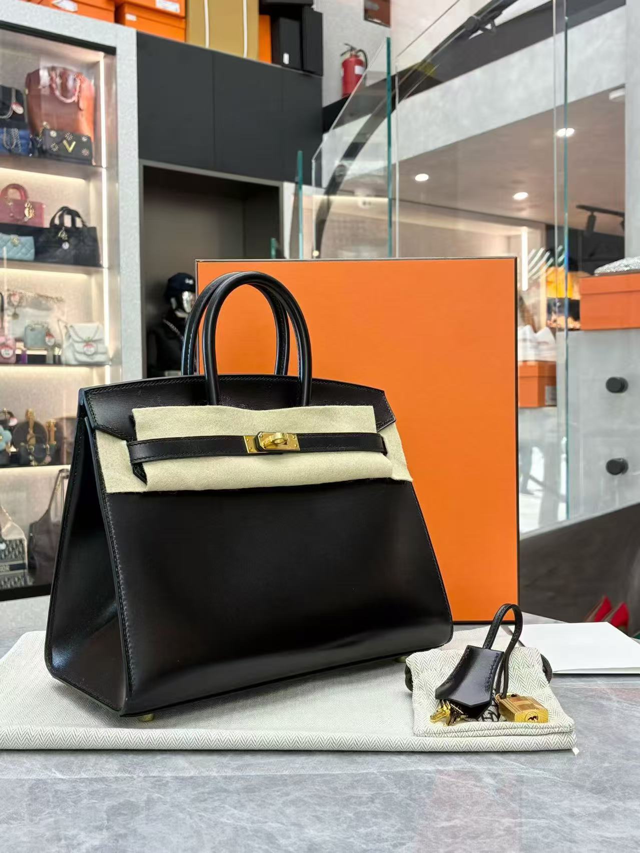 Hermès black Birkin 25 tote bag crafted from Veau Madame leather