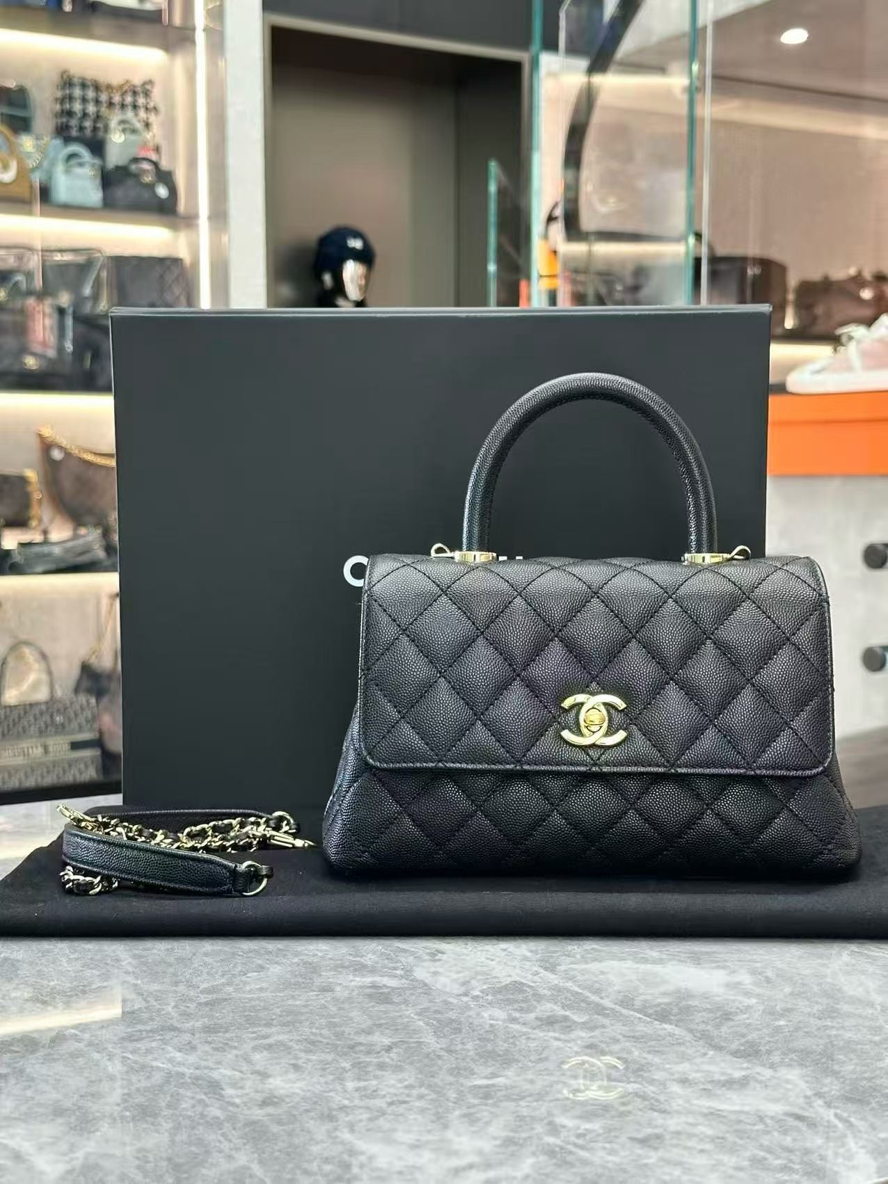 Chanel Coco Handle handbag, featuring quilted caviar leather, a top handle, and light gold-tone hardware