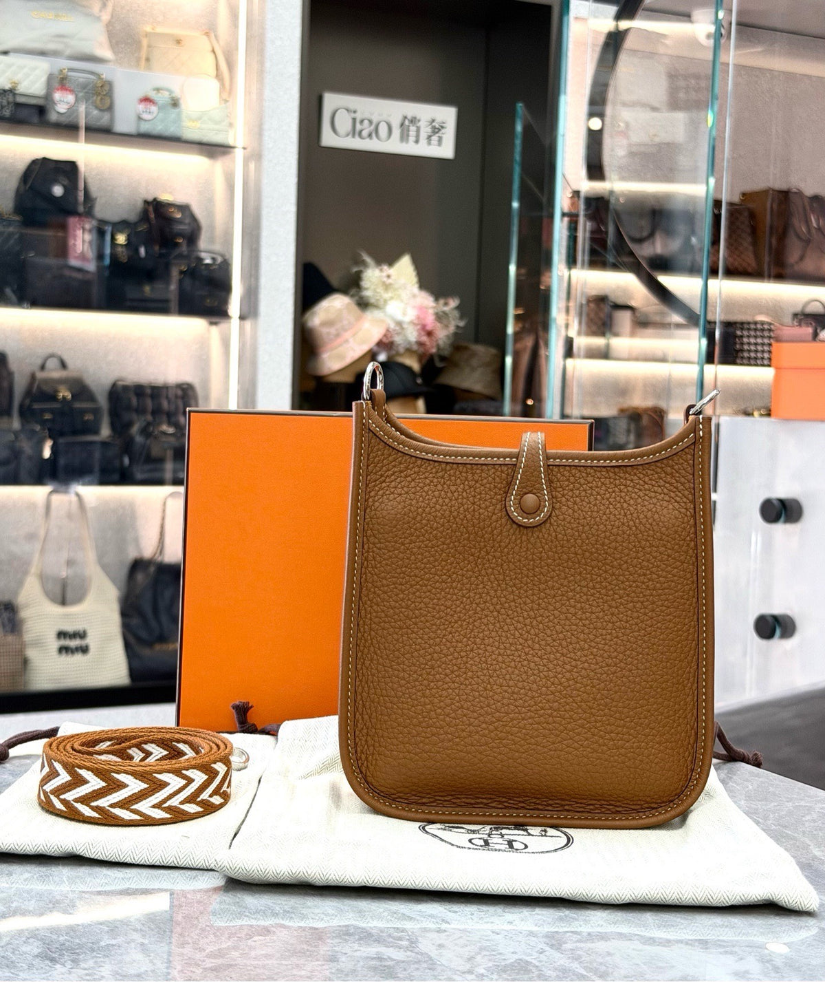 HERMÈS Mini Evelyne – Gold Taurillon Clemence, Palladium Hardware, Geometric Woven Strap, U Stamp, Brand New