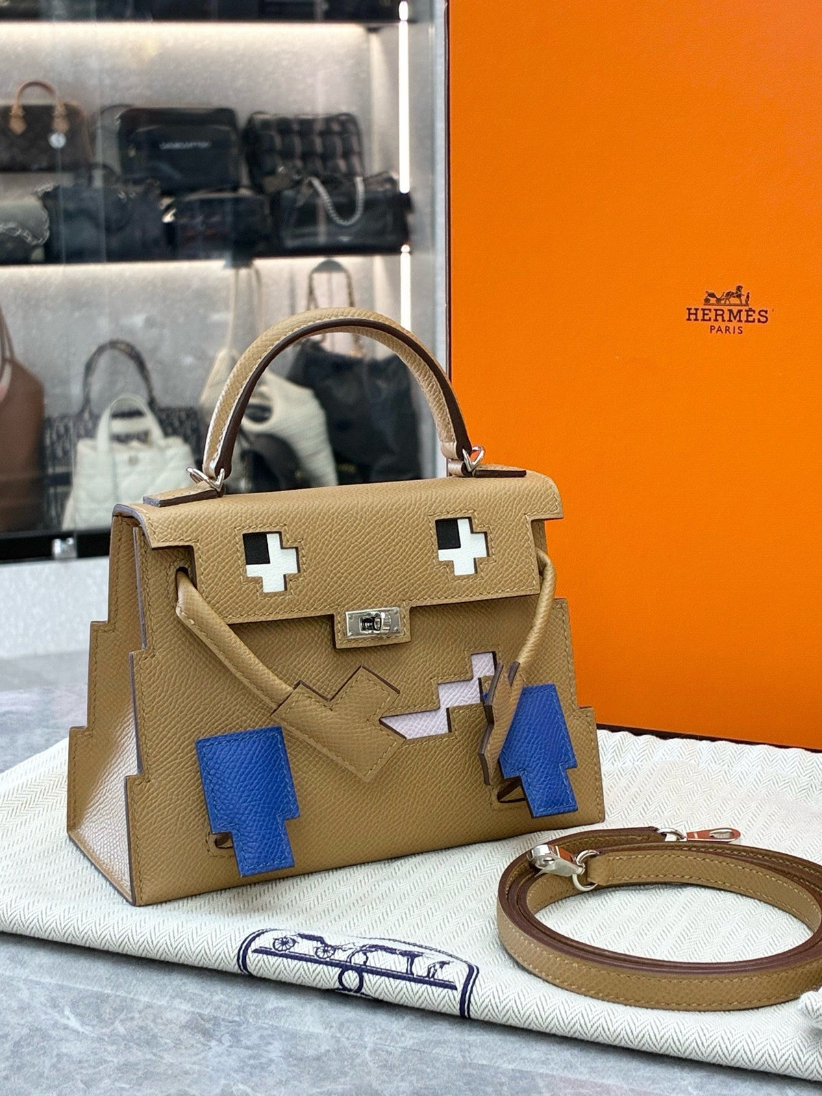 HERMÈS Kelly Doll – Biscuit Epsom with Bleu France Pixel Mosaic, Palladium Hardware, W Stamp, Brand New