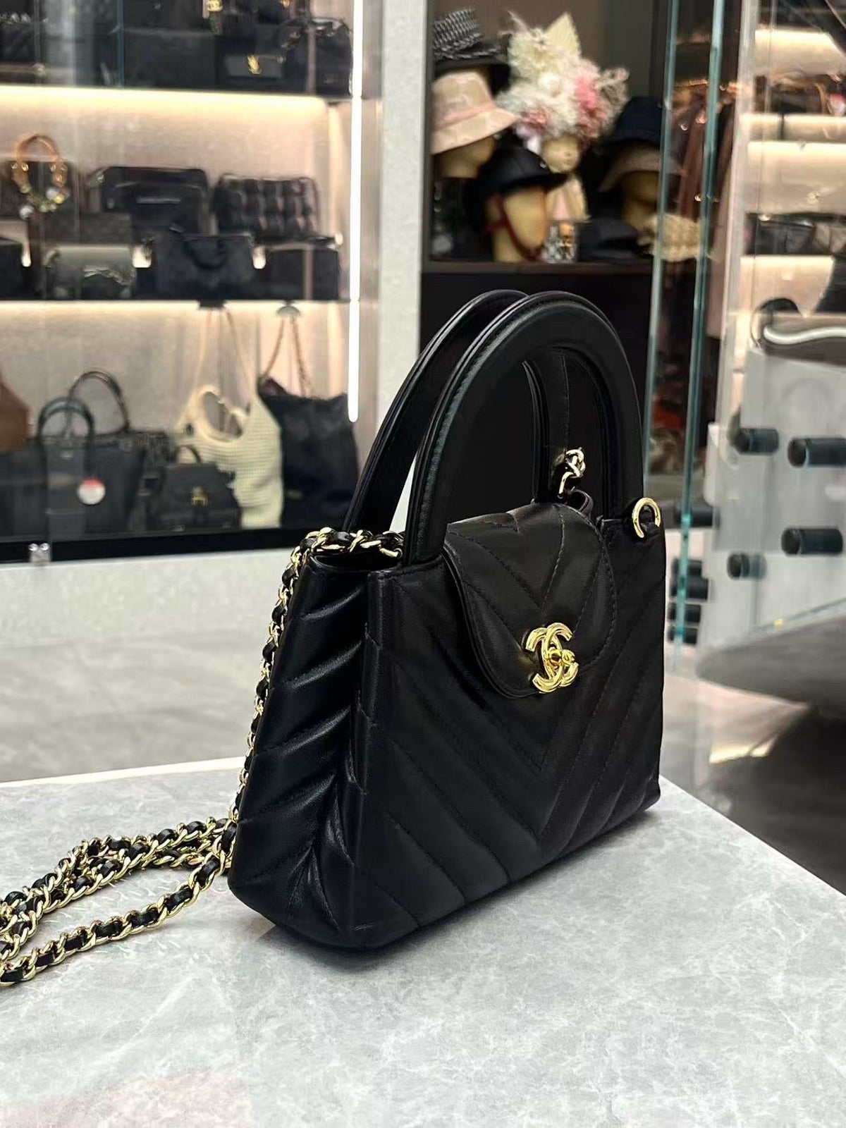 CHANEL Kelly Top Handle Flap – Black Chevron-Quilted Lambskin, Gold Hardware, Very Good Pre-Owned