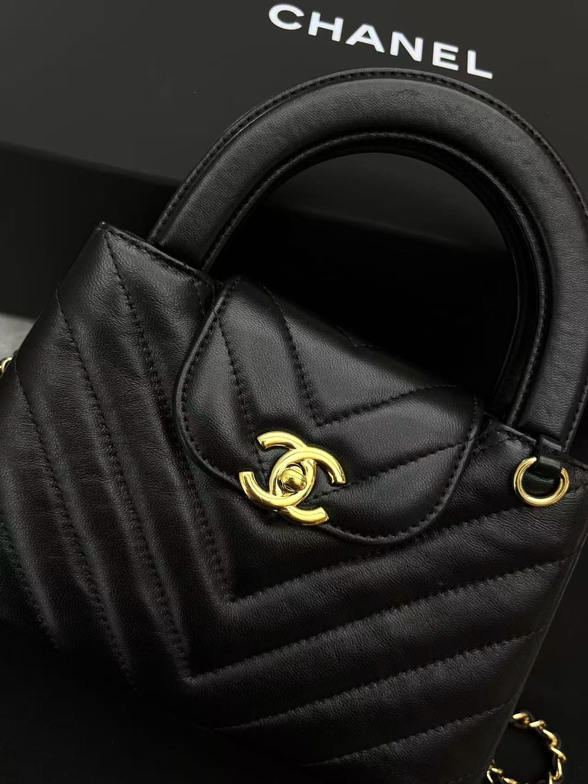 CHANEL Kelly Top Handle Flap – Black Chevron-Quilted Lambskin, Gold Hardware, Very Good Pre-Owned