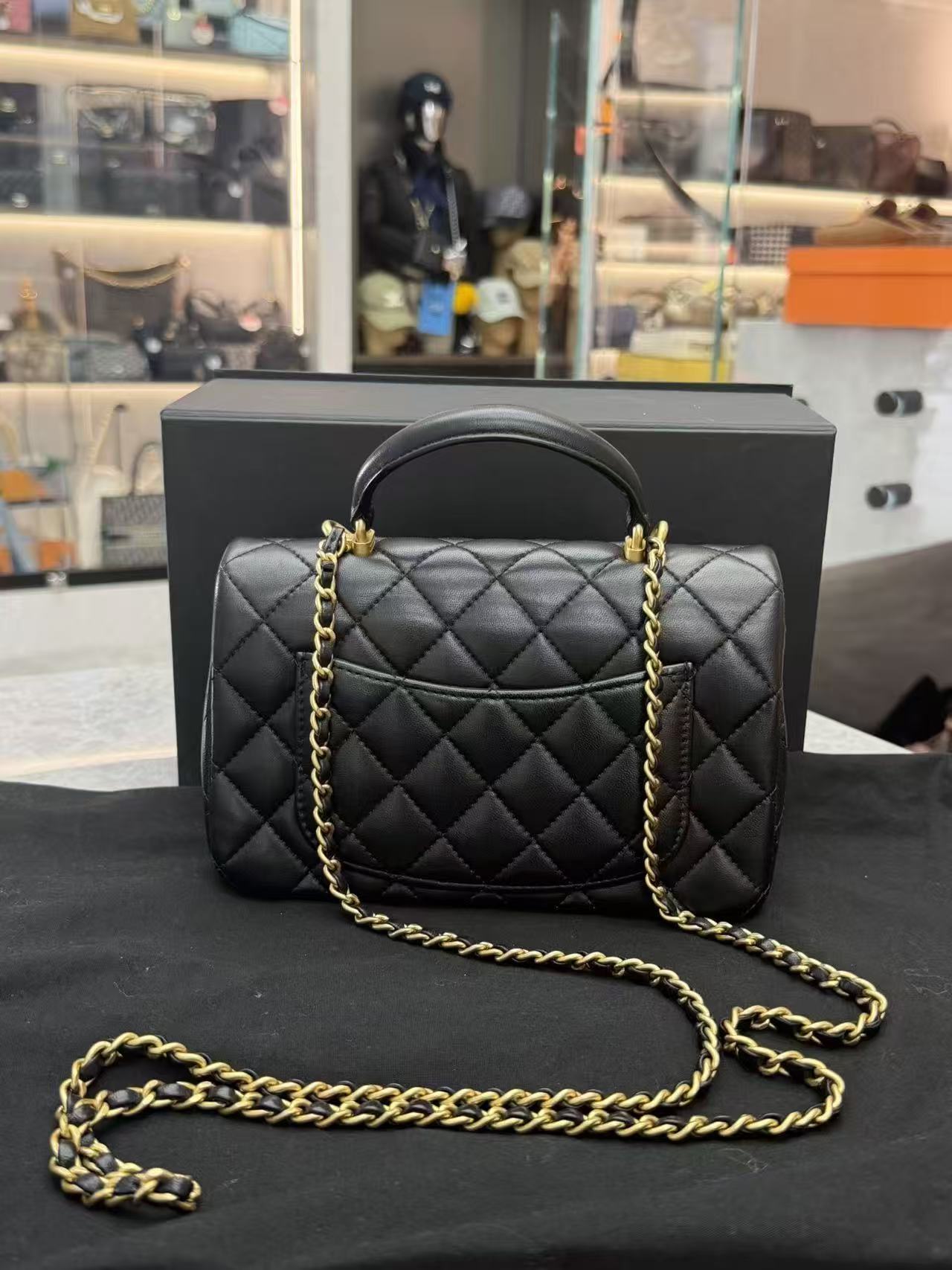 Chanel Top Handle Mini Rectangular Flap Bag in black lambskin leather with antique gold hardware