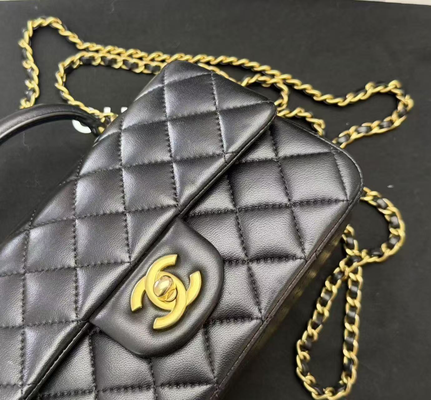 Chanel Top Handle Mini Rectangular Flap Bag in black lambskin leather with antique gold hardware