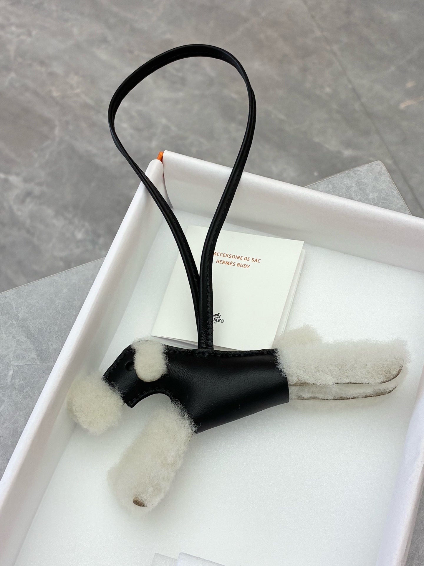 Hermès Budy dog bag charm in black lambskin and white shearling