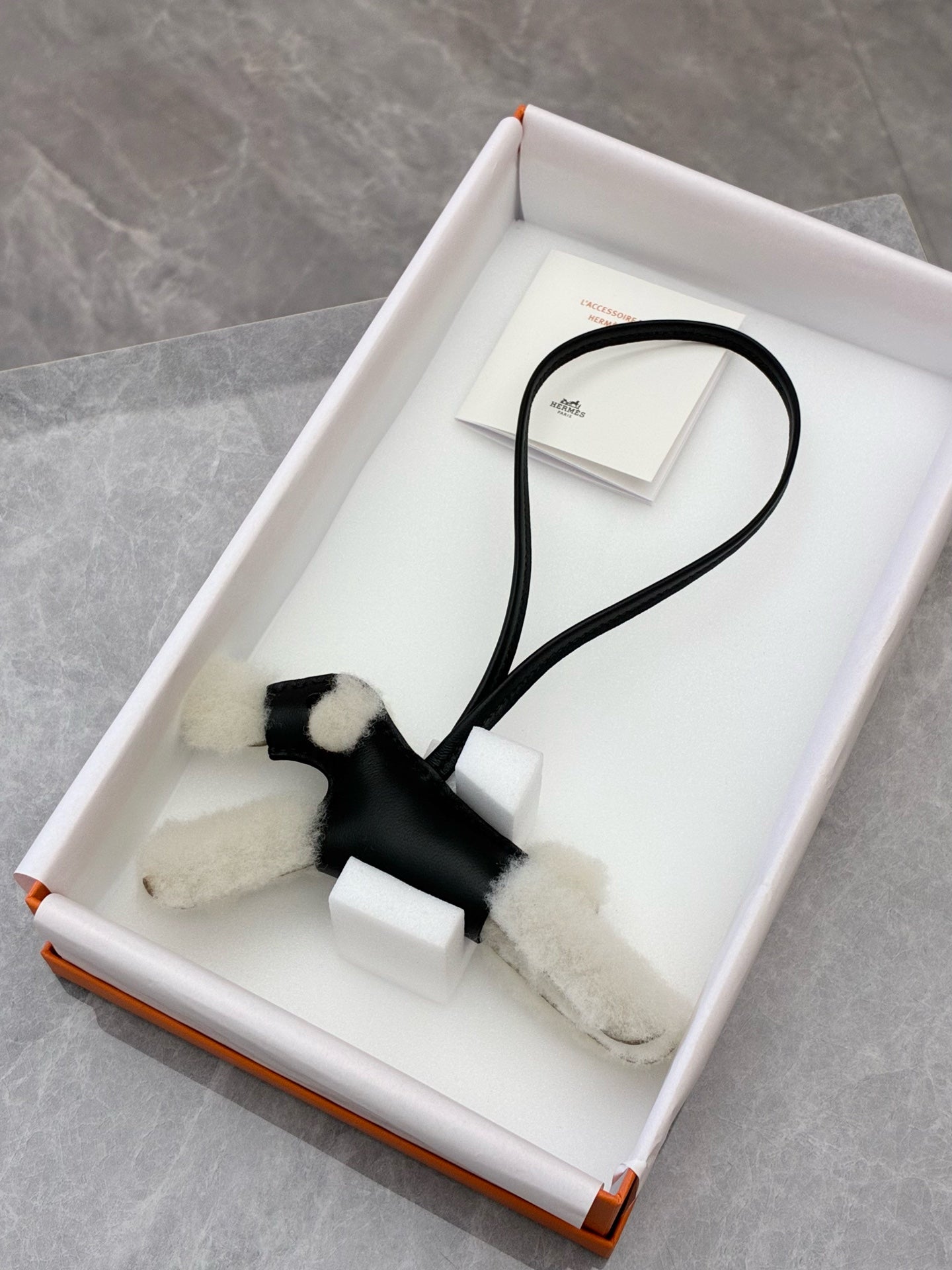 Hermès Budy black lambskin and shearling dog charm side view